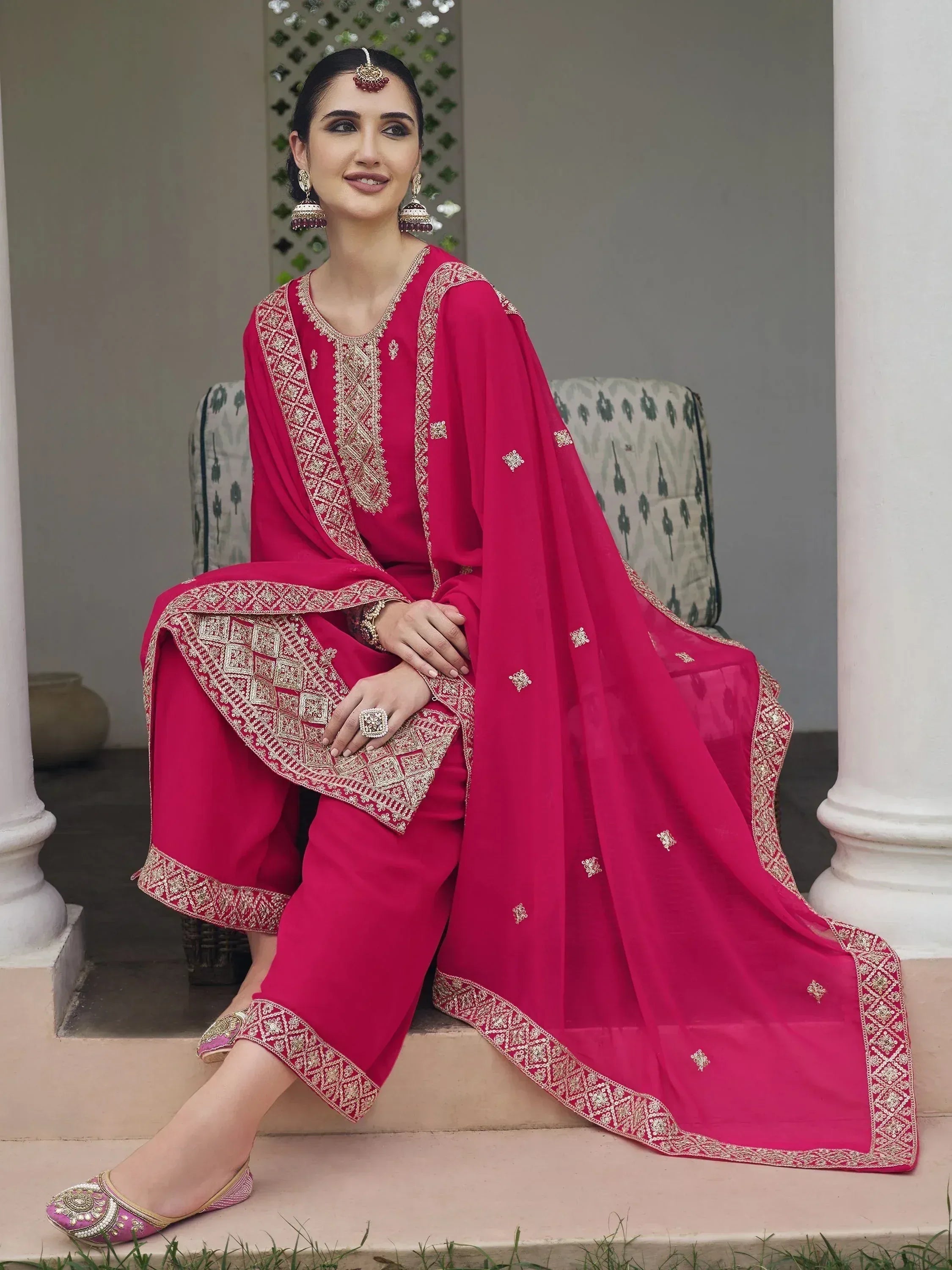 Woman in pink embroidered salwar kameez with dupatta, traditional Indian ethnic wear