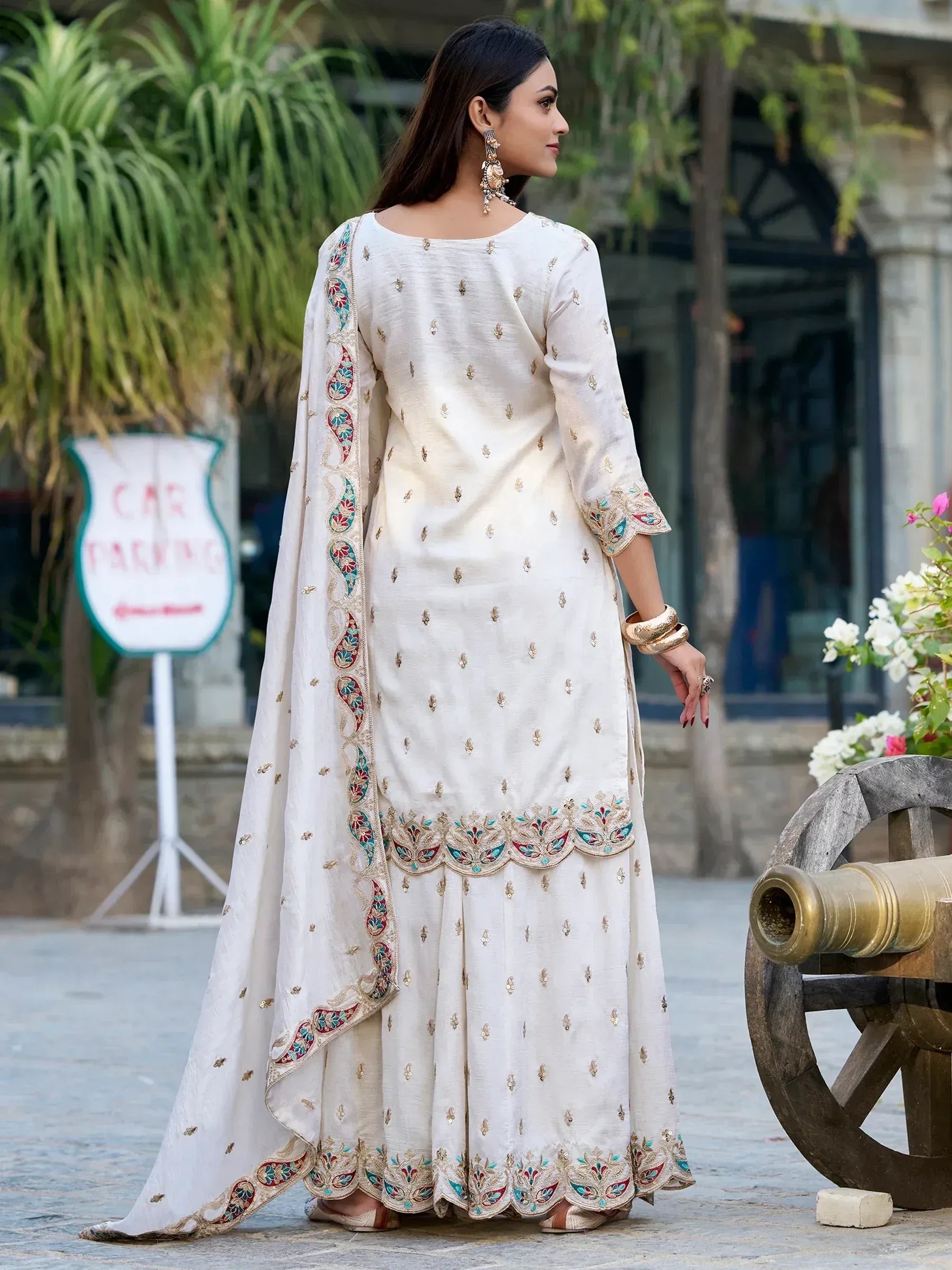 Elegant white embroidered salwar kameez with colorful paisley dupatta, perfect for Indian ethnic occasions.