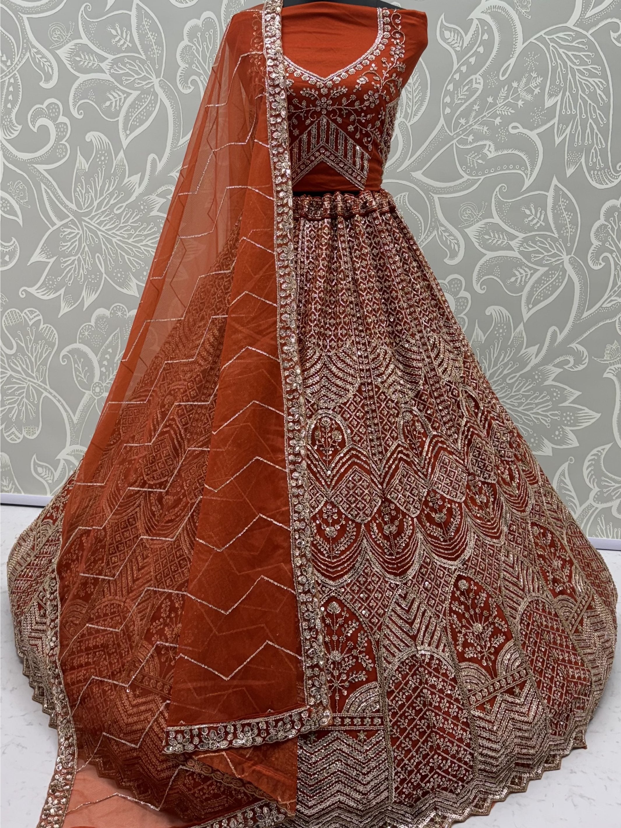 Wonderful Rust Orange Sequins Net Wedding Wear Lehenga Choli