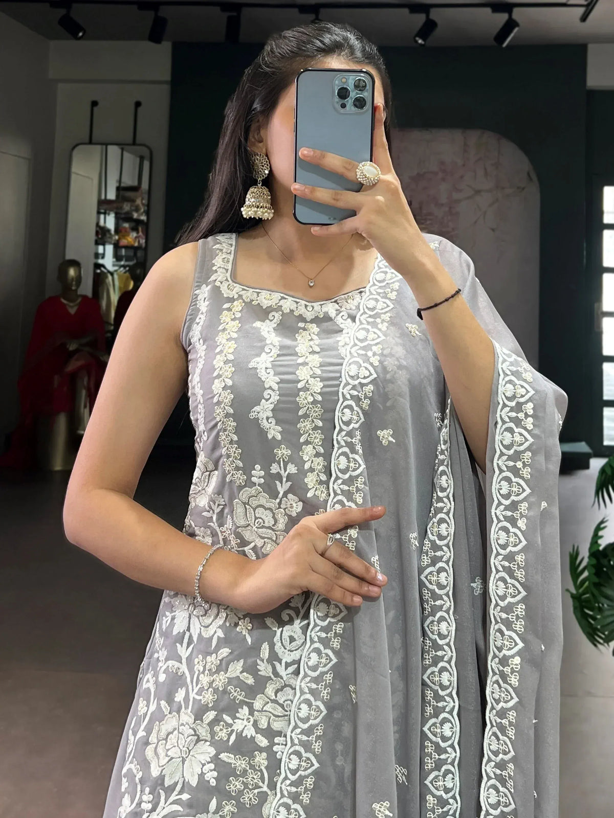 Grey embroidered ethnic gown with white floral detailing, perfect for Indian occasions