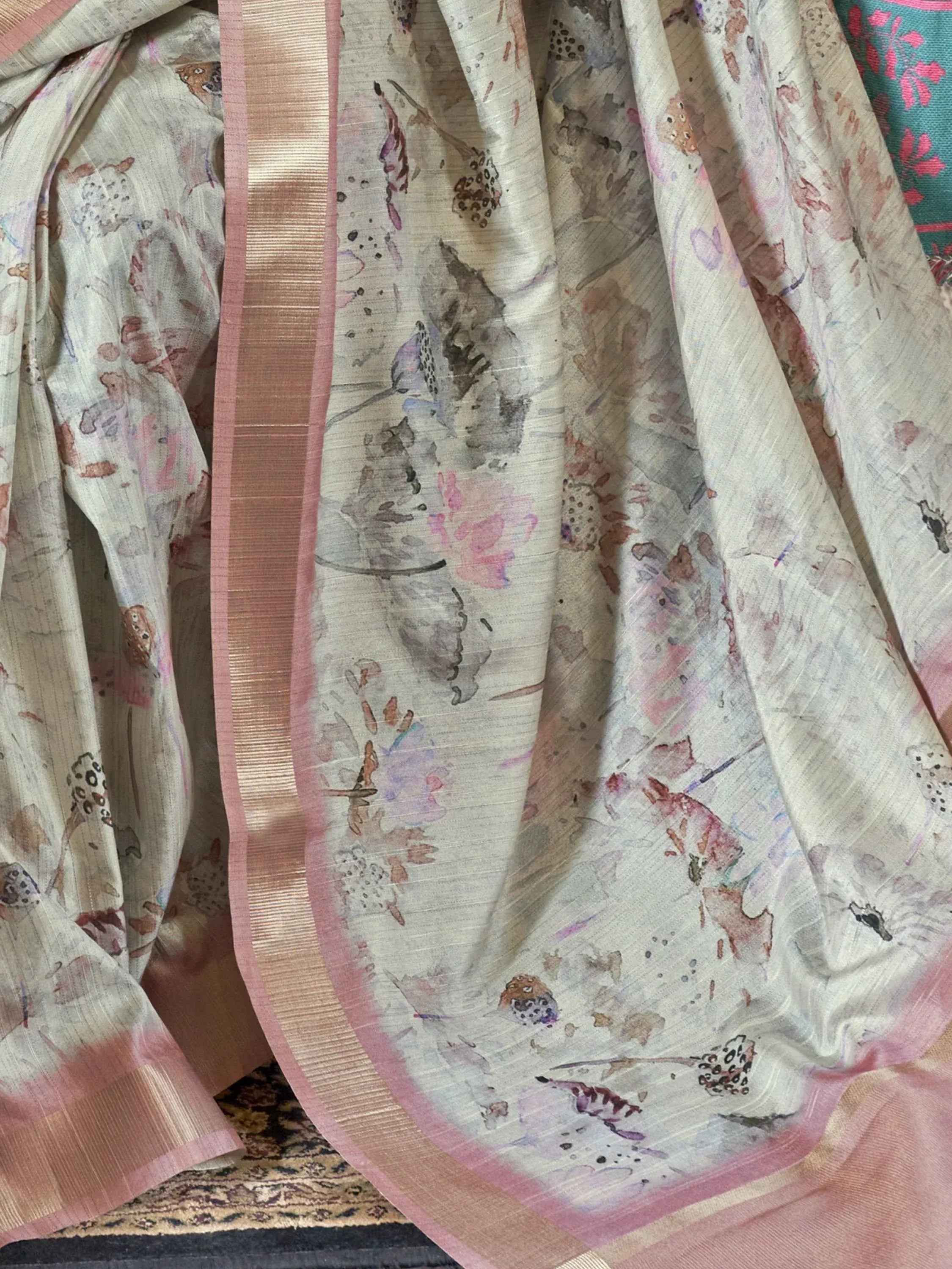 Elegant floral print saree with pink border, perfect for ethnic wear occasions.