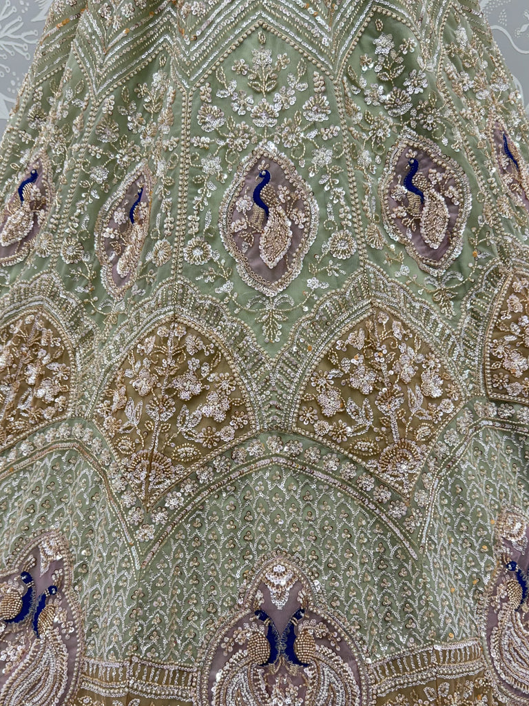 Luxurious Pista Green Hand Work Net Reception Wear Lehenga Choli With Dupatta