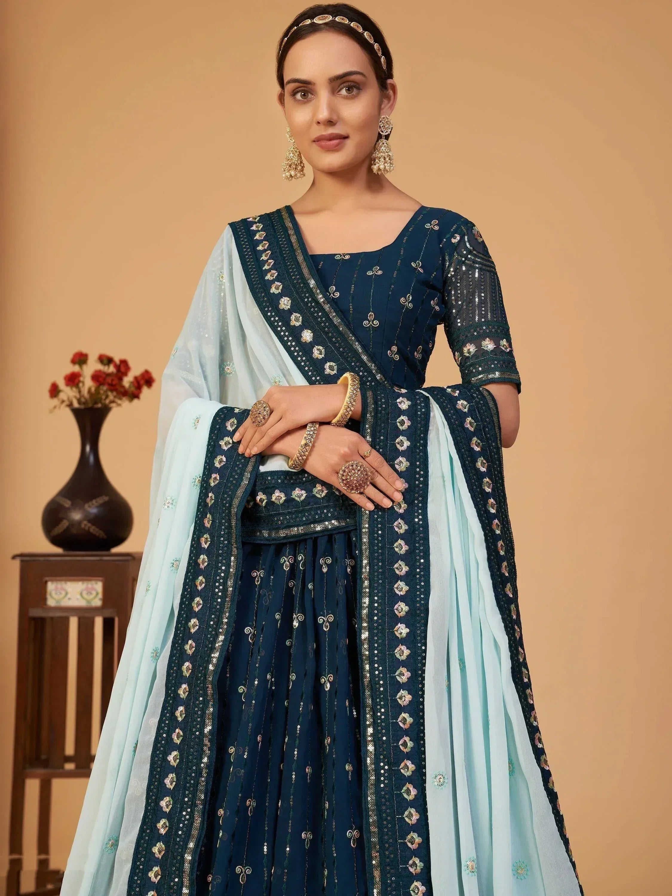 Elegant navy blue embroidered lehenga choli with light blue dupatta, perfect for Indian ethnic occasions.