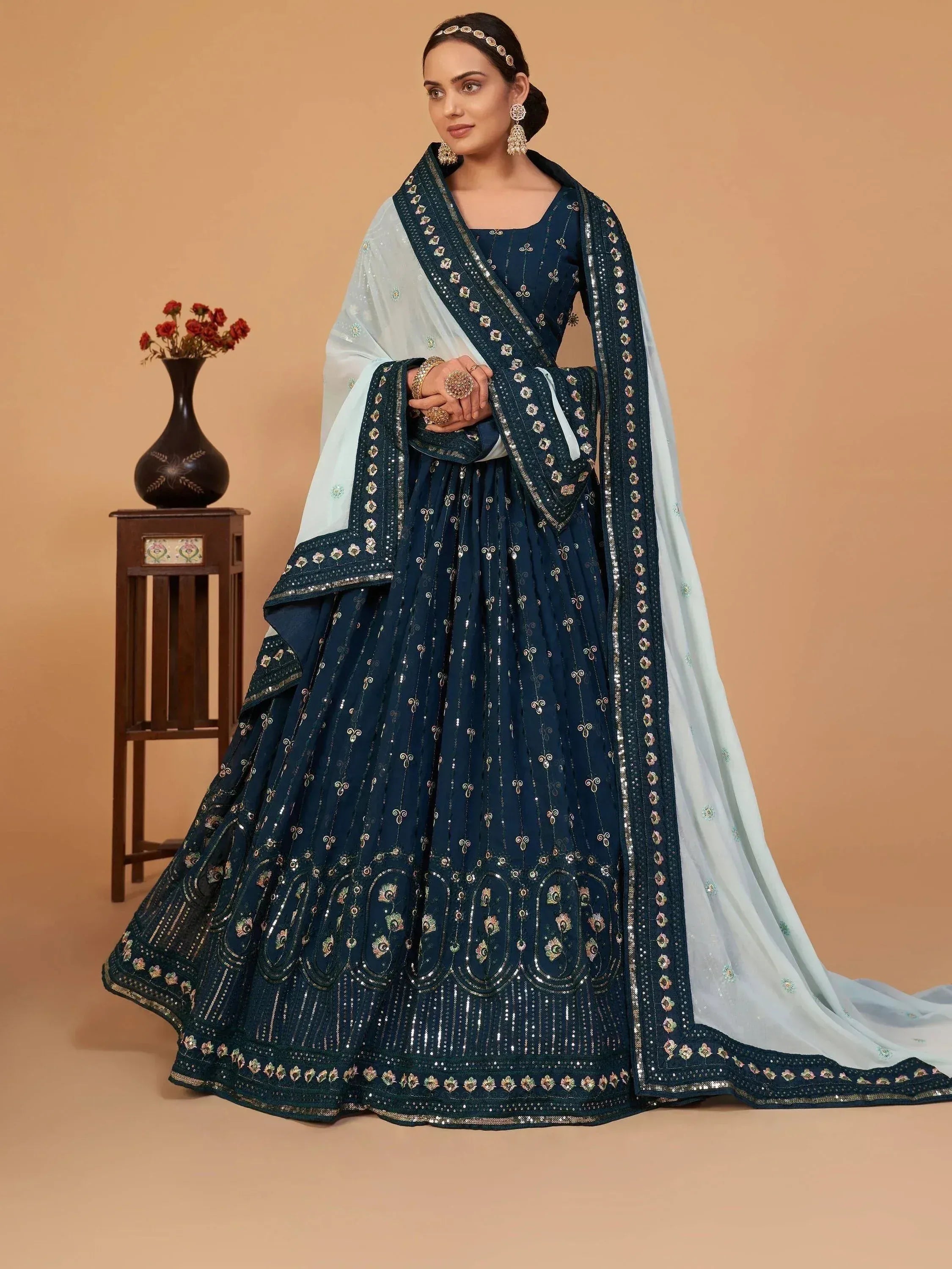 Elegant navy blue embroidered lehenga choli with light blue dupatta, perfect for Indian ethnic wear occasions.