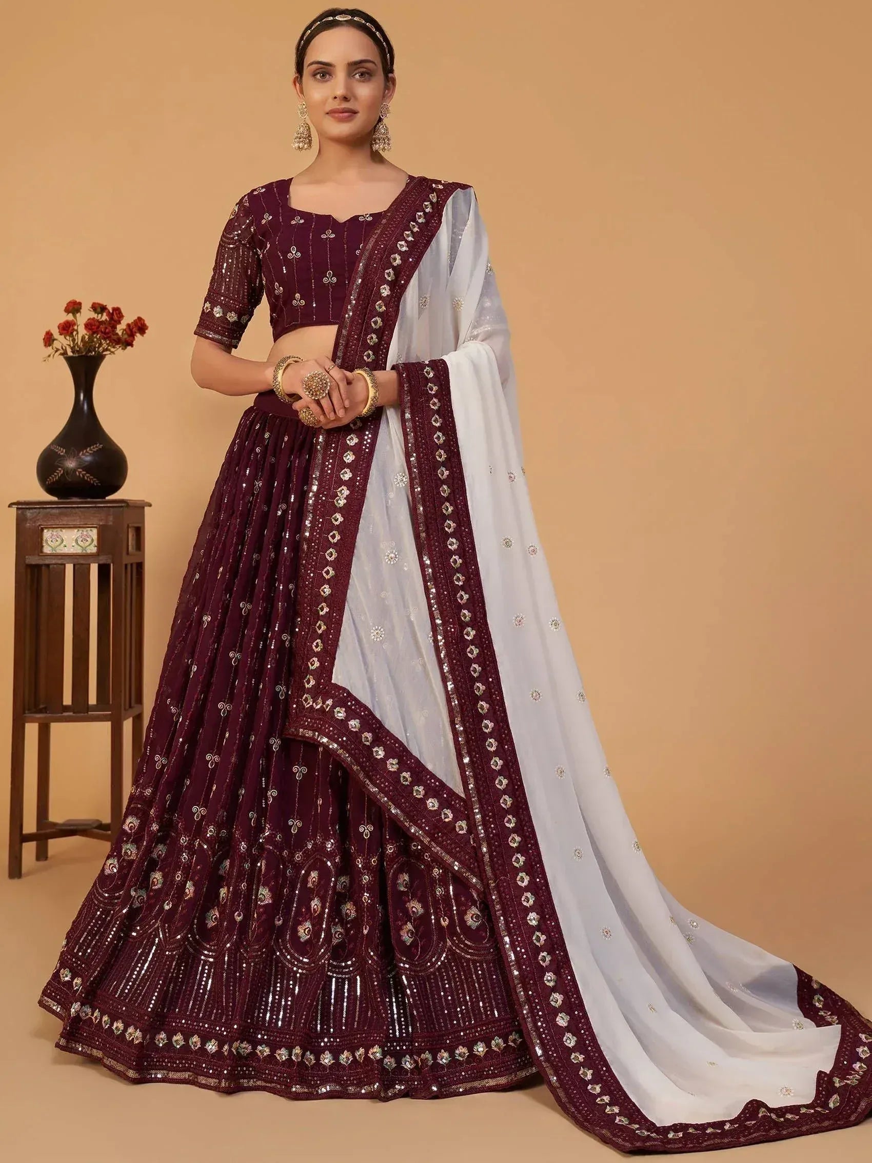 Maroon and white embroidered lehenga choli with sequin work, perfect for Indian weddings and festive occasions.