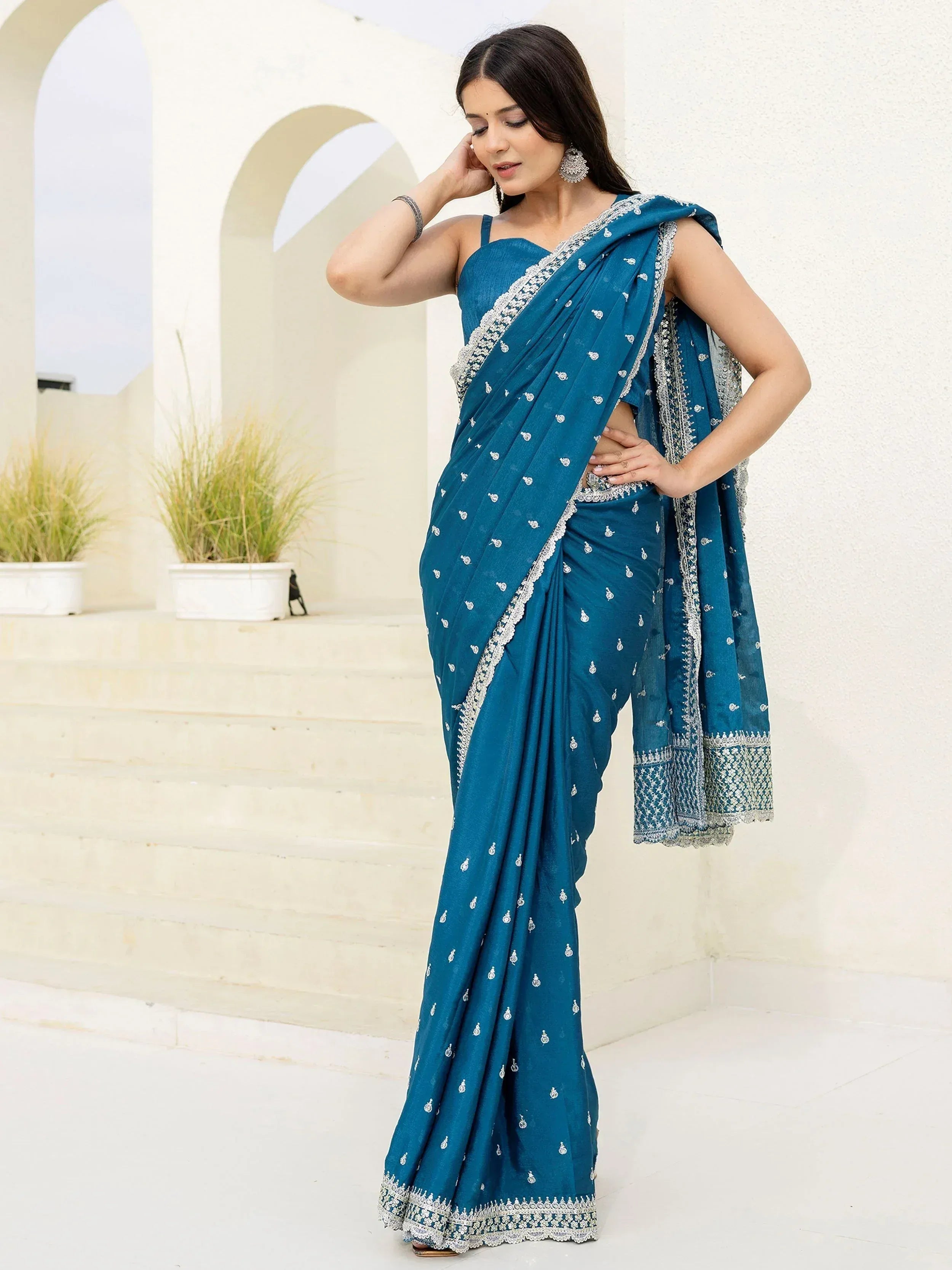 Teal blue embroidered saree with silver detailing, perfect for Indian ethnic wear occasions
