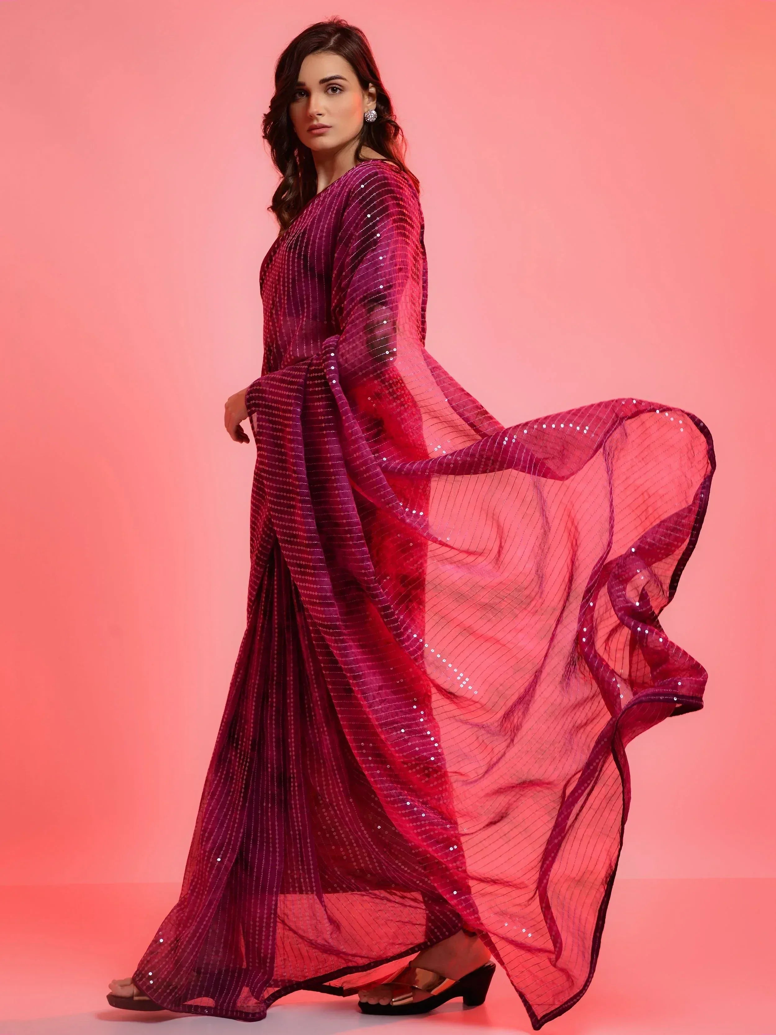 Elegant purple ethnic gown with sequin detailing, flowing sheer sleeves, perfect for festive occasions.