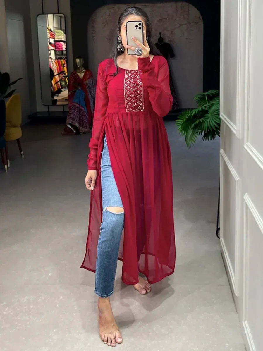 Red embroidered ethnic gown with side slit paired with ripped jeans, perfect for fusion fashion