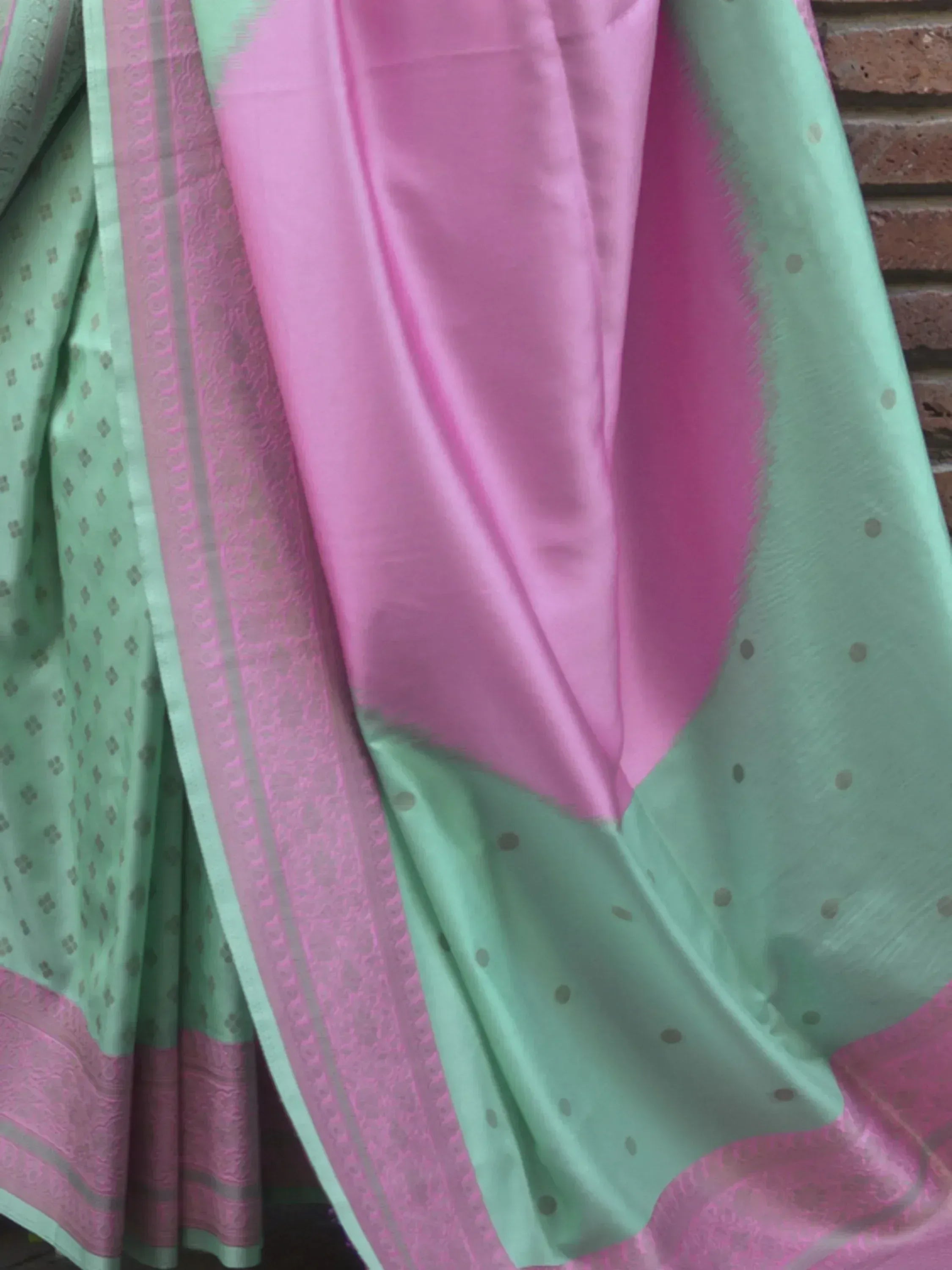 Mint green and pink ethnic saree with woven border and subtle motifs, perfect for Indian occasions