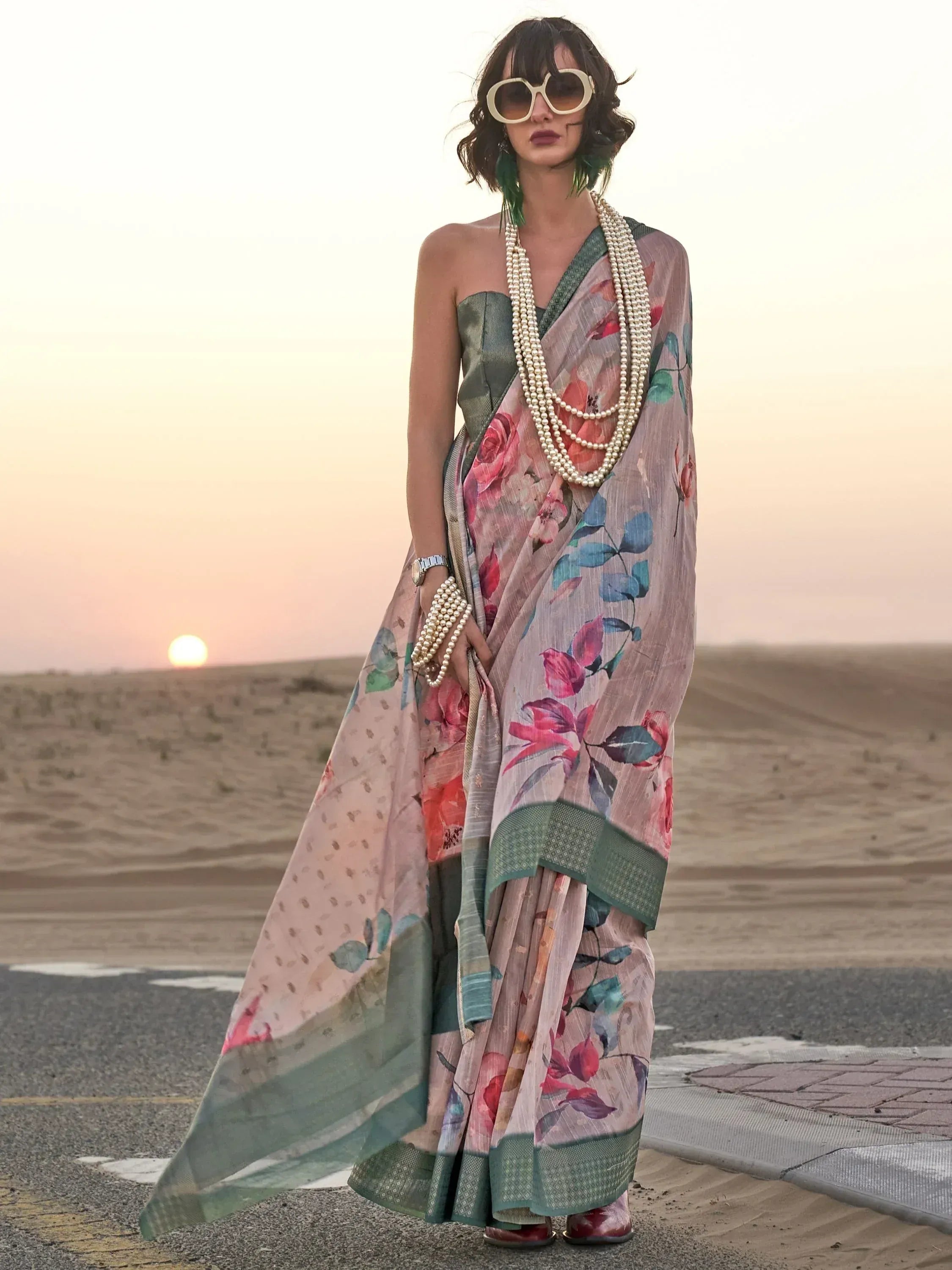 Woman in floral print saree with pearl accessories at sunset, ethnic wear fashion