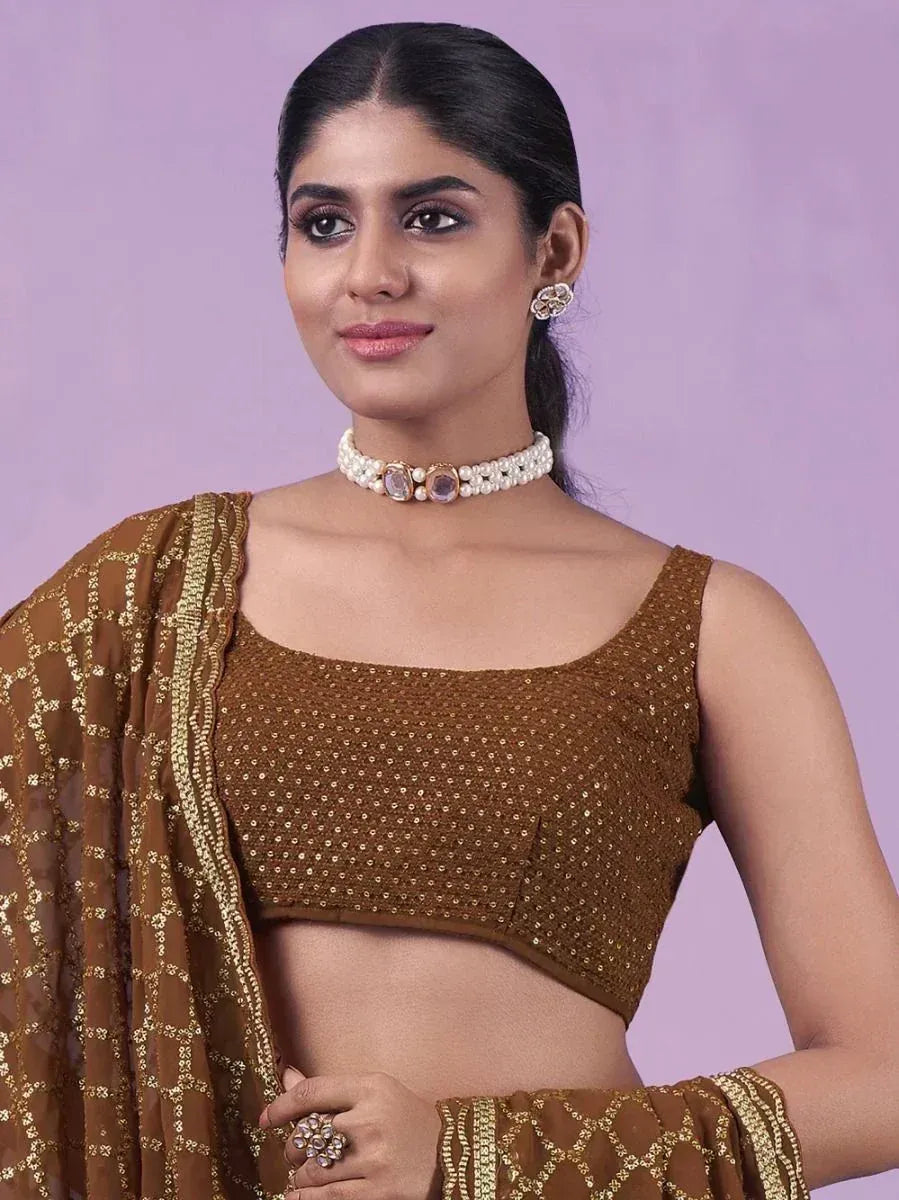 Woman in brown sequin lehenga choli with pearl choker, ethnic Indian wear