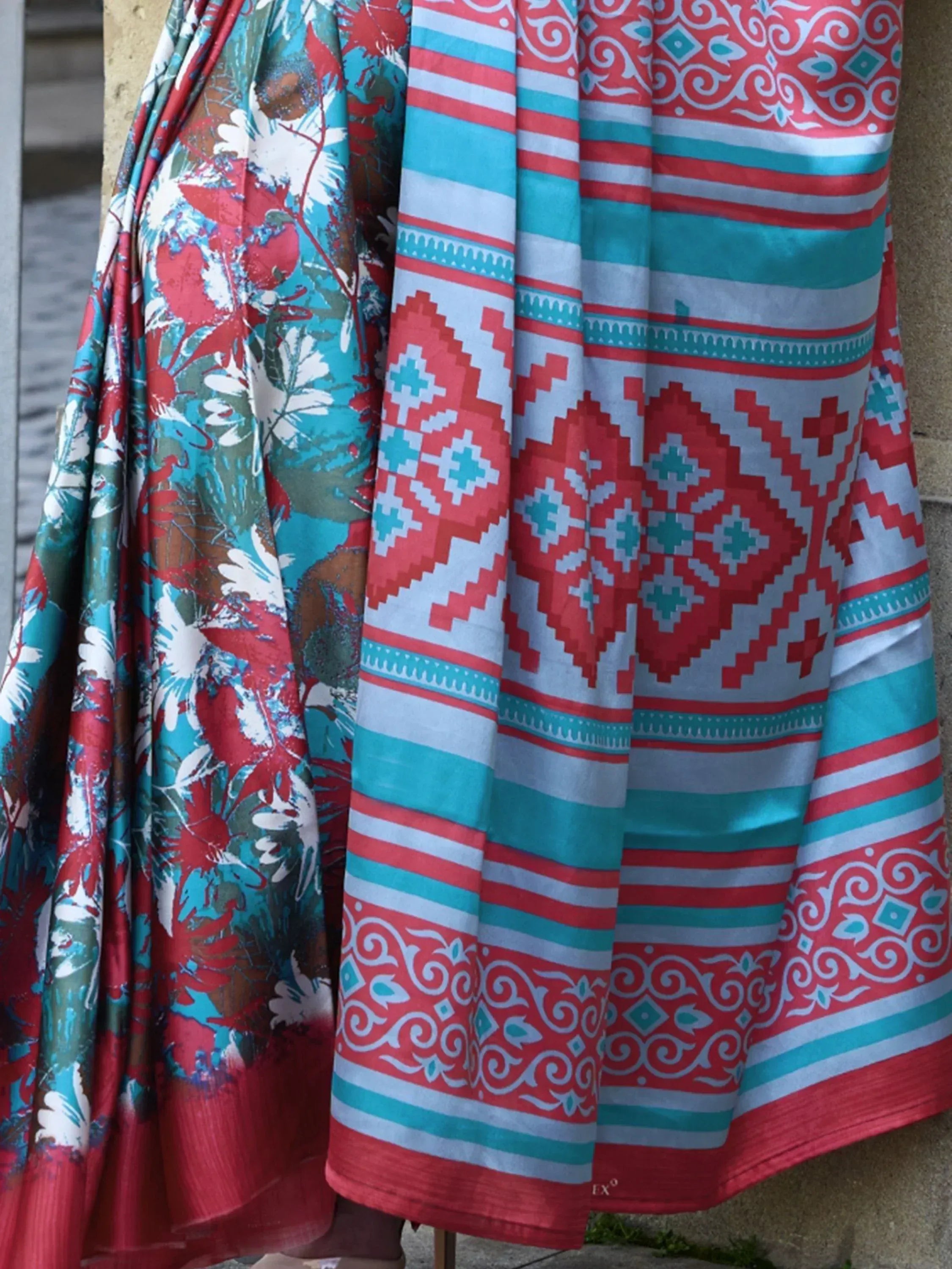 Vibrant red and turquoise ethnic sarees with floral and geometric patterns, perfect for Indian celebrations.