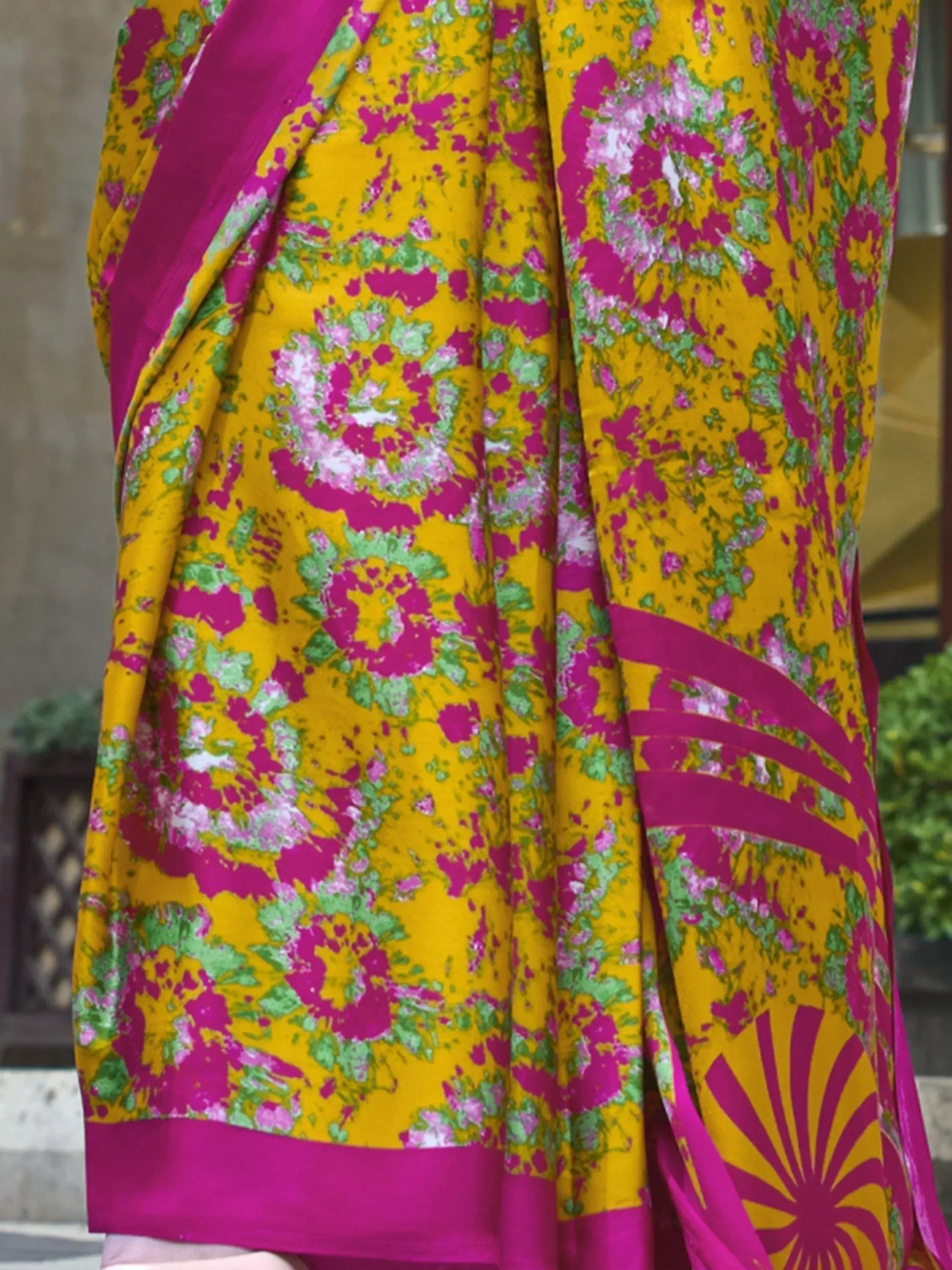 Vibrant yellow saree with pink and green floral print, perfect for Indian ethnic wear occasions.