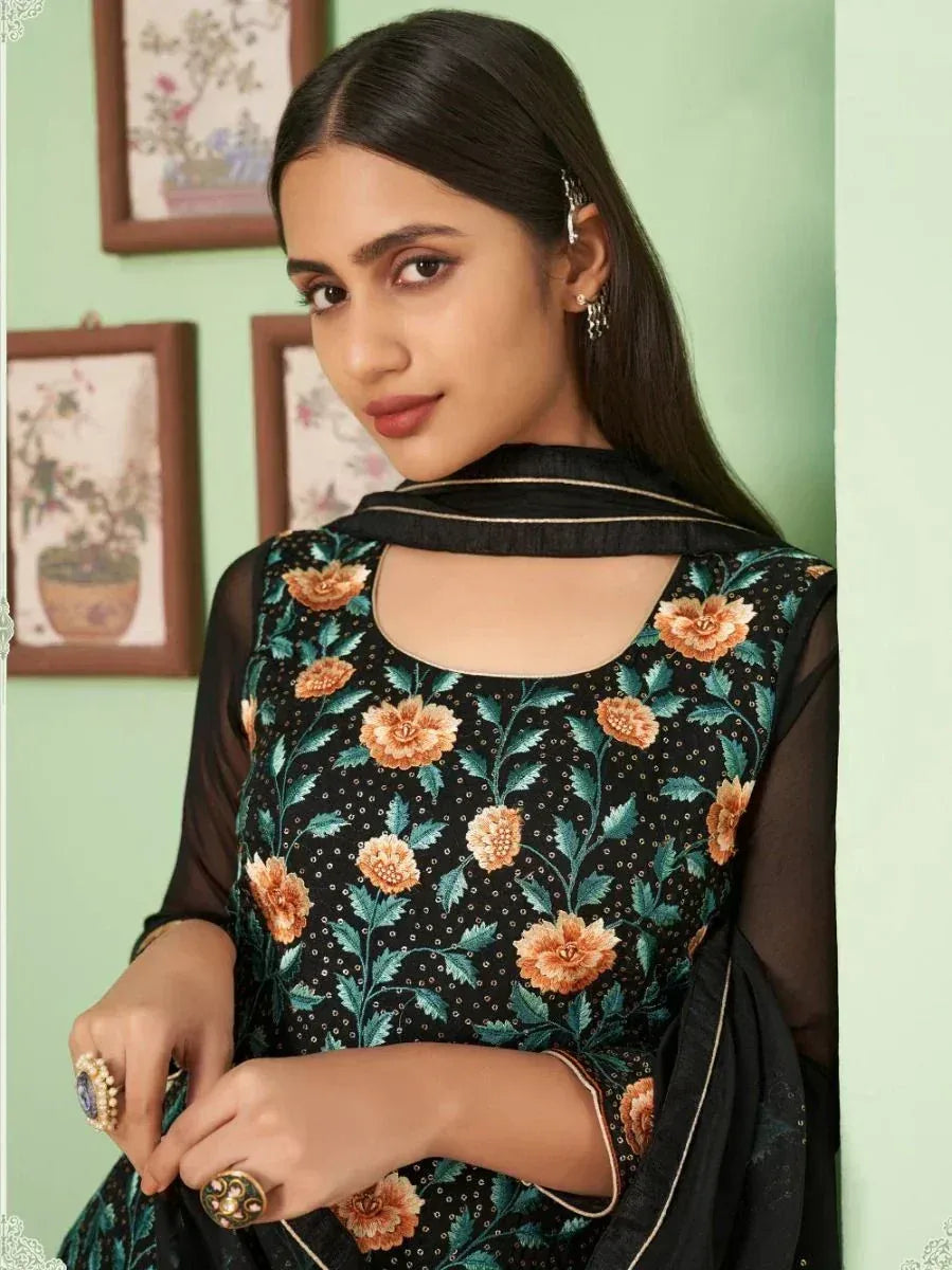 Elegant black floral embroidered ethnic gown with sheer sleeves and statement rings