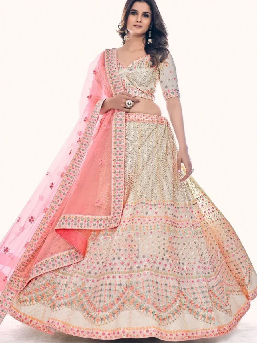 Elegant cream and pink embroidered lehenga choli with floral dupatta, perfect for Indian weddings and festive occasions.