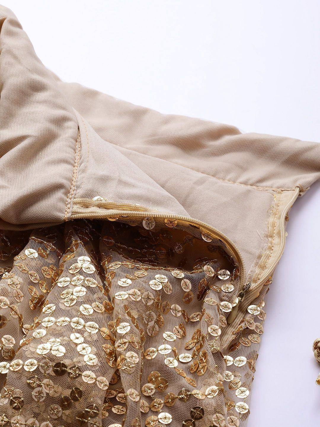 Beige ethnic gown with gold sequin detailing and zipper closure, perfect for festive occasions