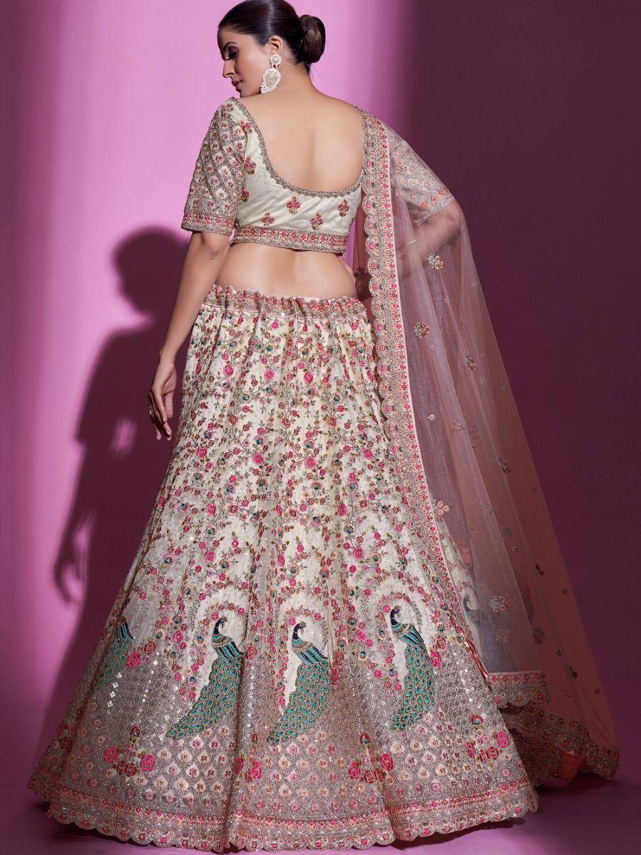 Elegant floral and peacock embroidered lehenga choli with sheer dupatta, perfect for Indian weddings and festive occasions.