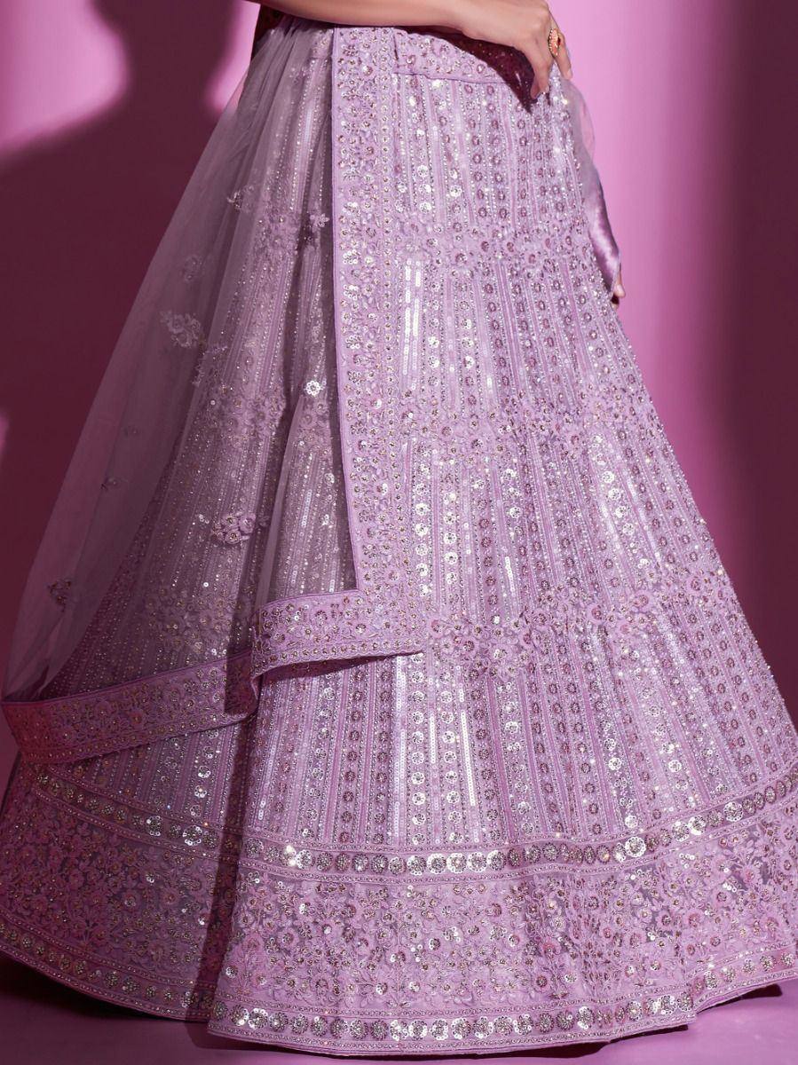 Lavender designer lehenga choli with intricate sequin embroidery and layered skirt, perfect for Indian weddings.