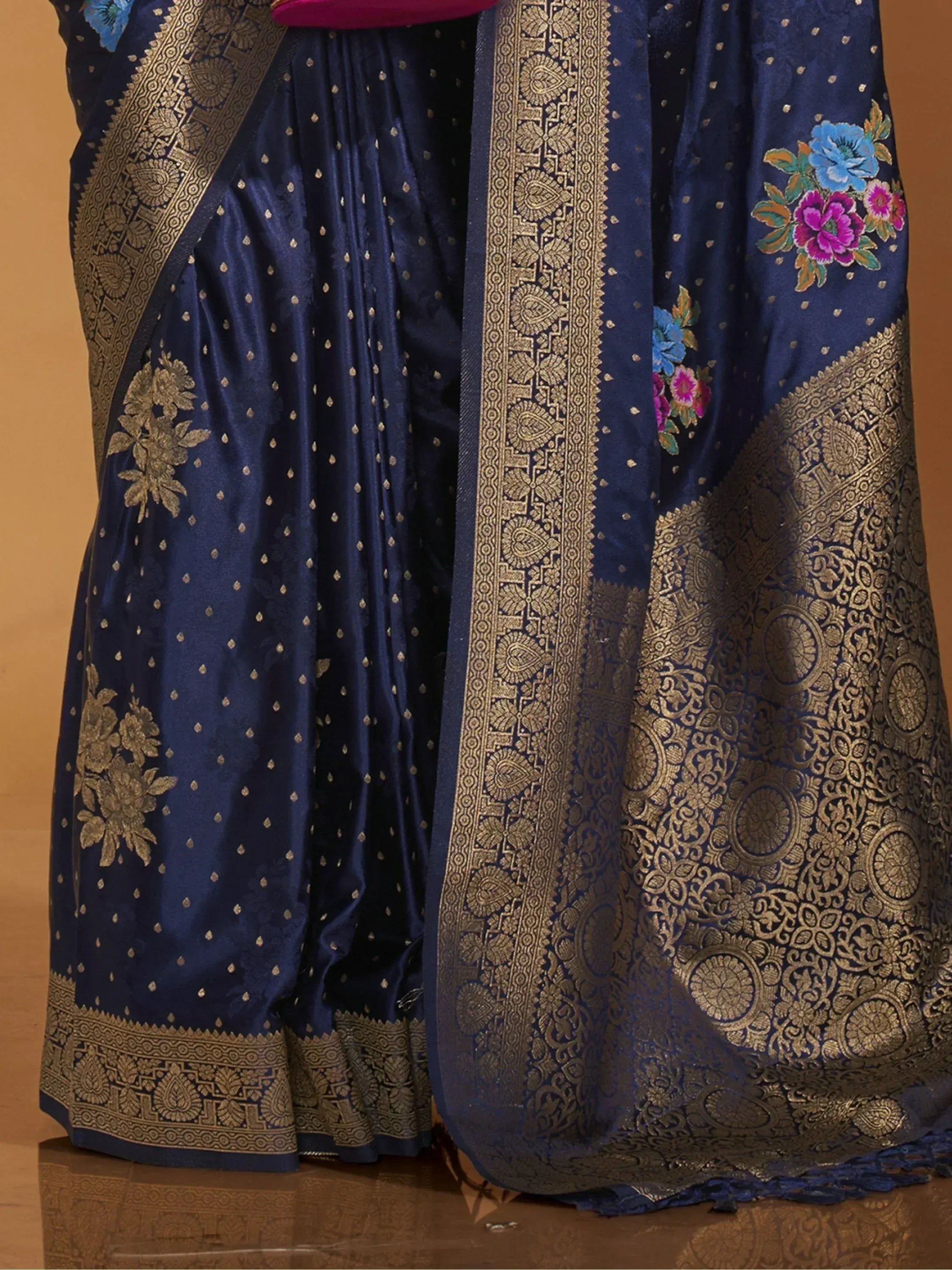 Navy blue designer saree with gold zari work, floral embroidery, and intricate border for ethnic wear