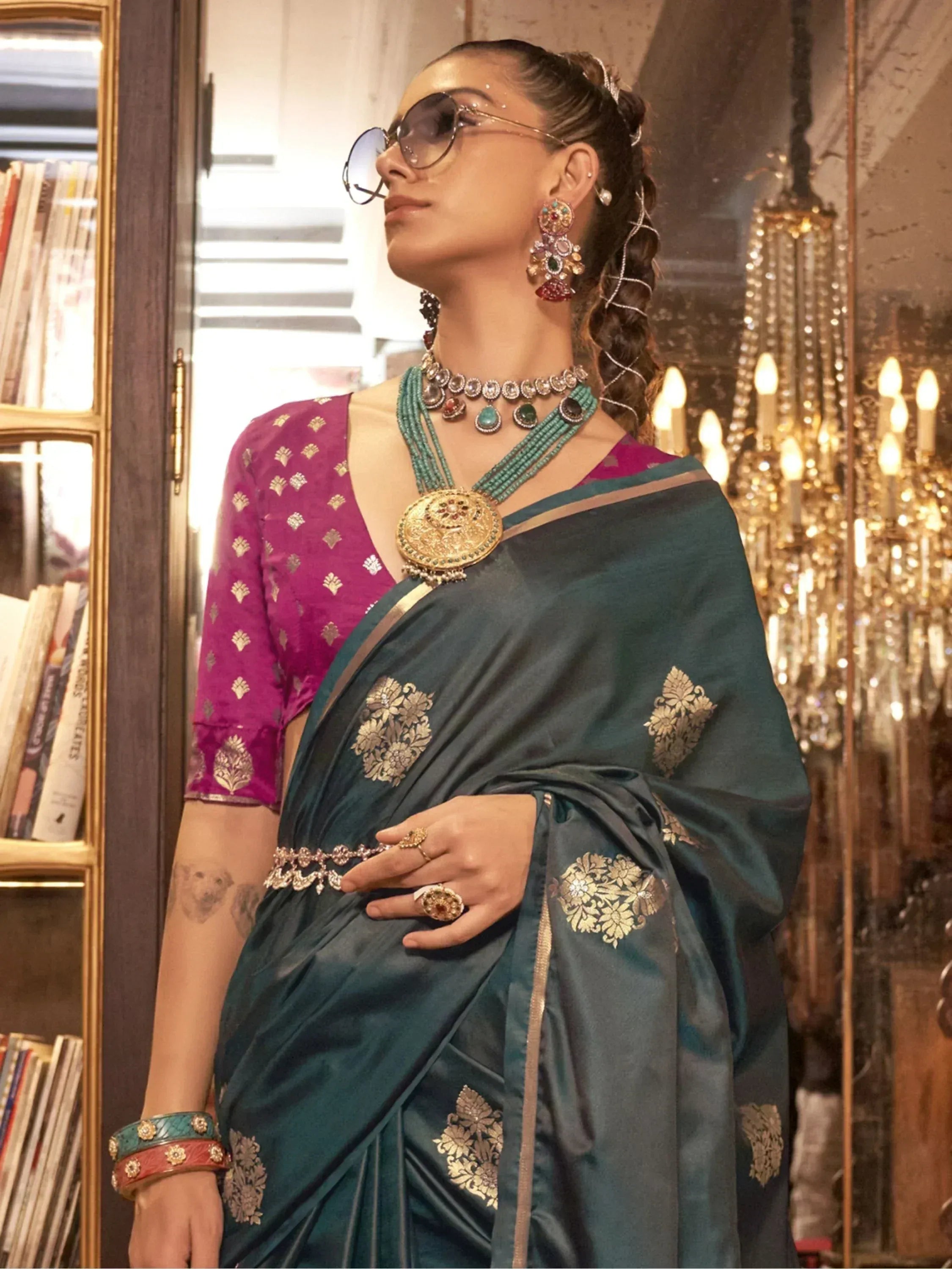 Elegant teal saree with gold floral embroidery, paired with a magenta blouse and traditional Indian jewelry for festive occasions.