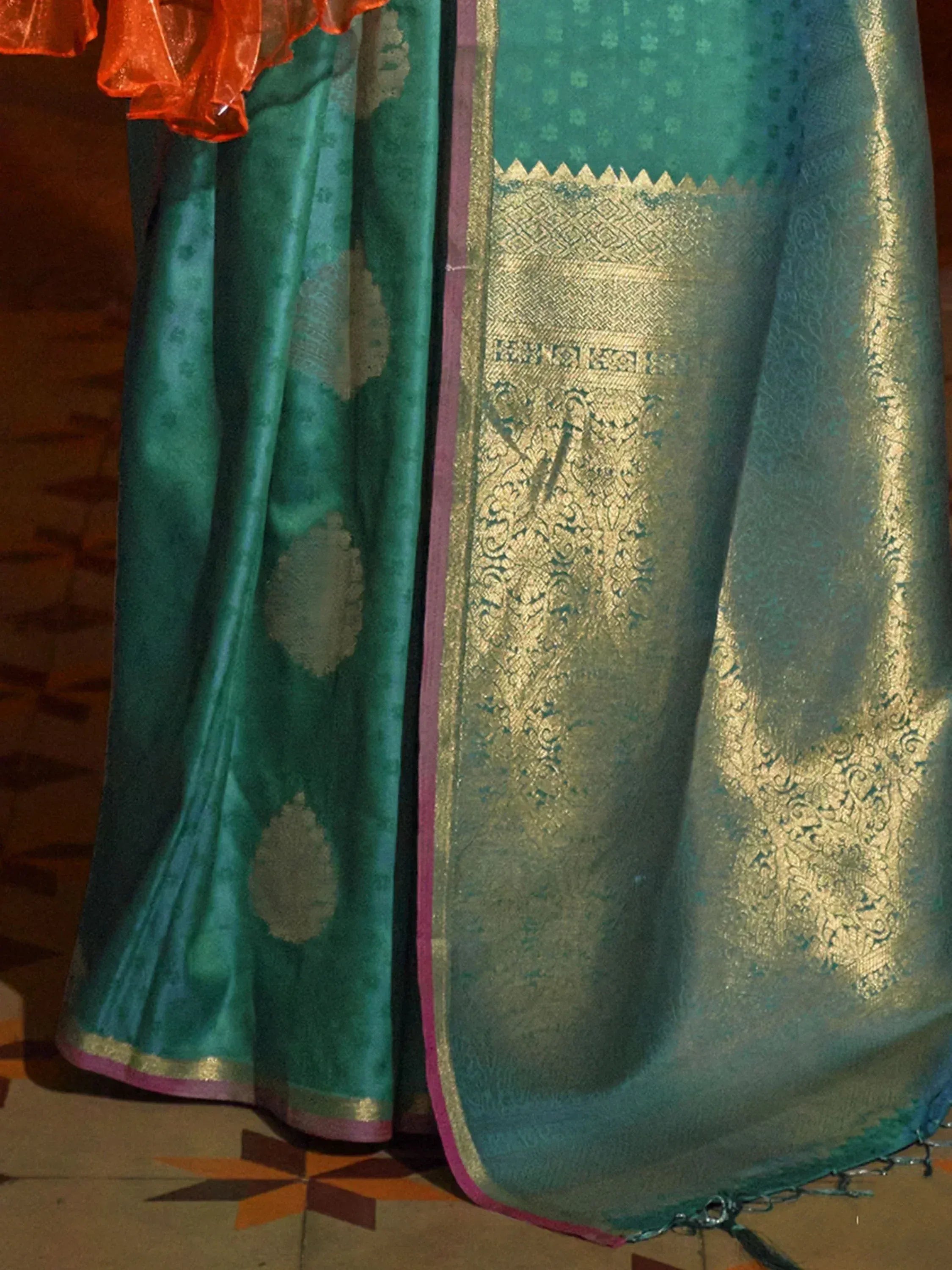Teal green saree with gold zari border and floral motifs, ethnic Indian wear