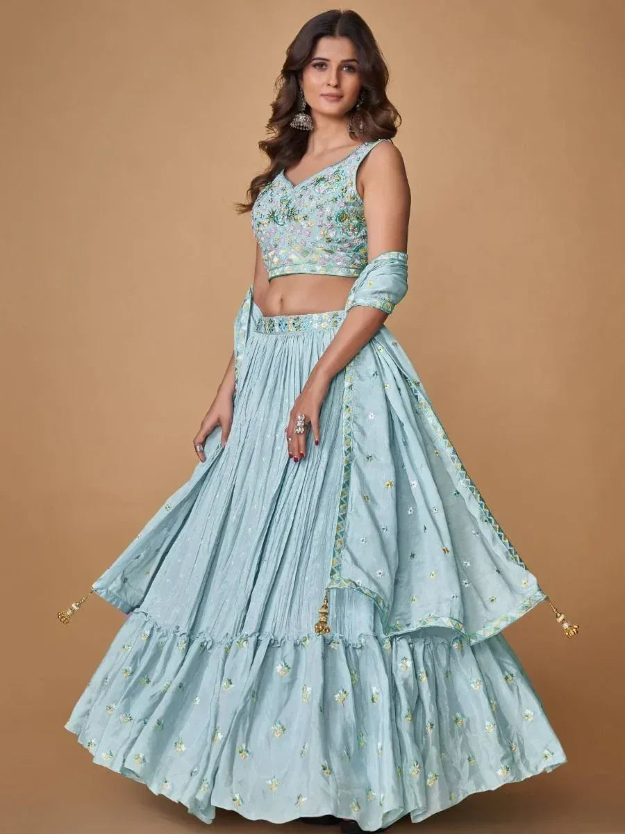 Light blue embroidered lehenga choli with floral motifs and layered skirt, perfect for Indian ethnic wear occasions
