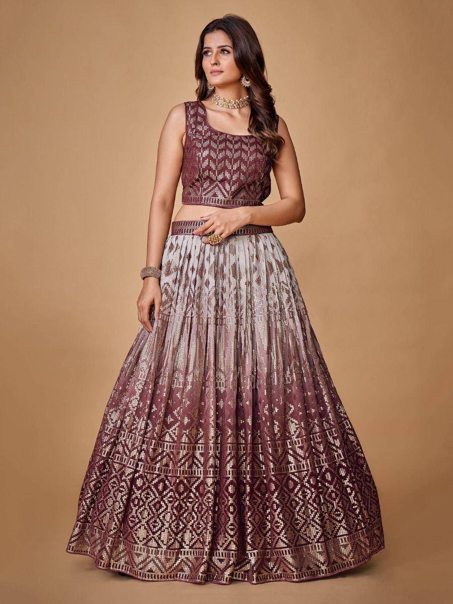 Elegant maroon and gold embroidered lehenga choli with intricate geometric patterns, perfect for Indian ethnic wear.