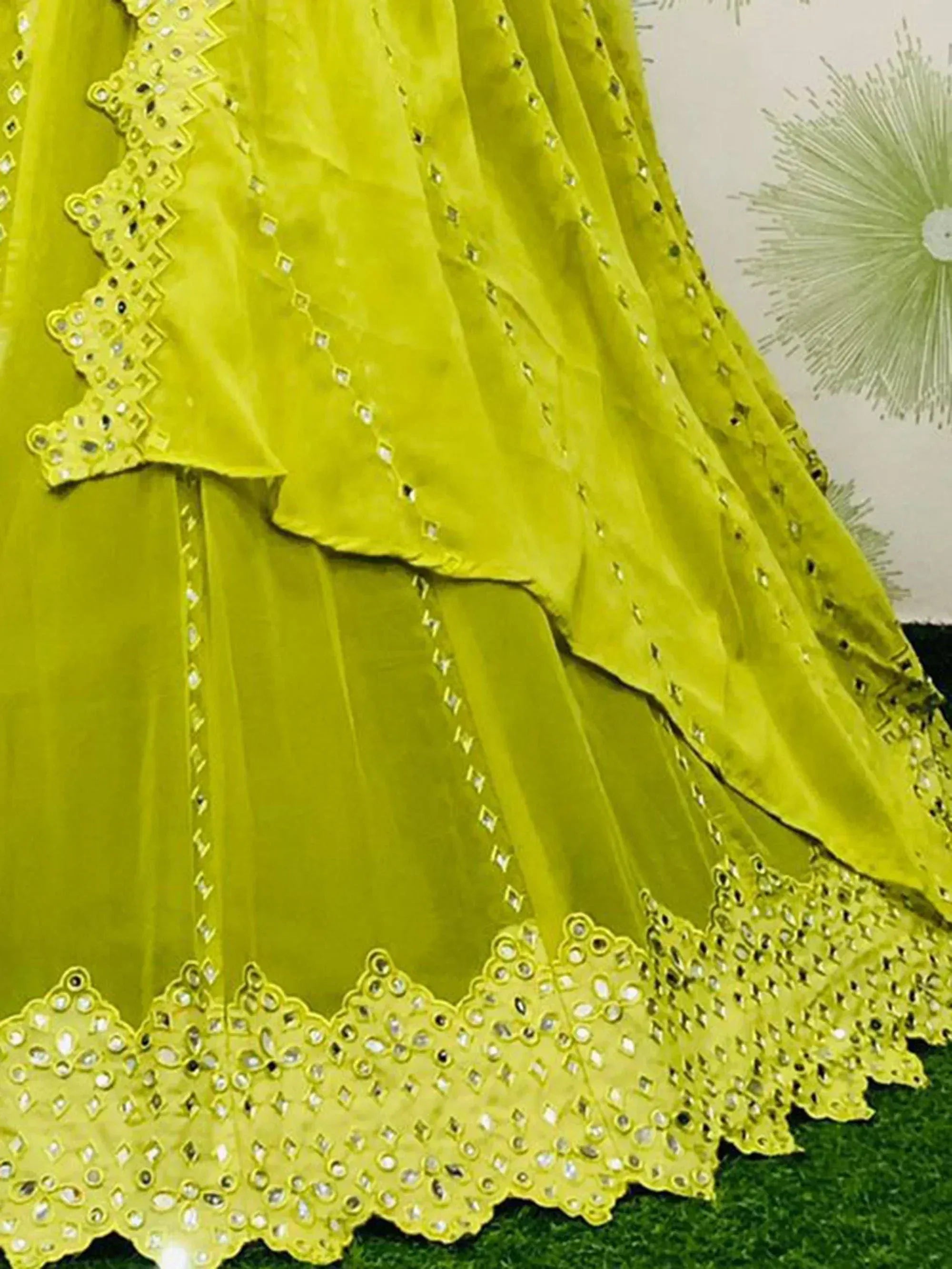 Lime green ethnic lehenga with mirror work and scalloped lace detailing, perfect for festive occasions.