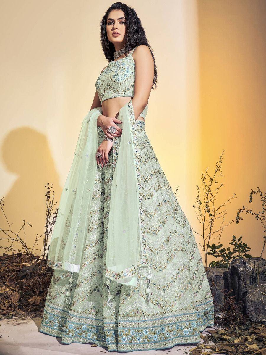 Mint green designer lehenga choli with intricate embroidery and floral patterns, perfect for Indian ethnic wear.