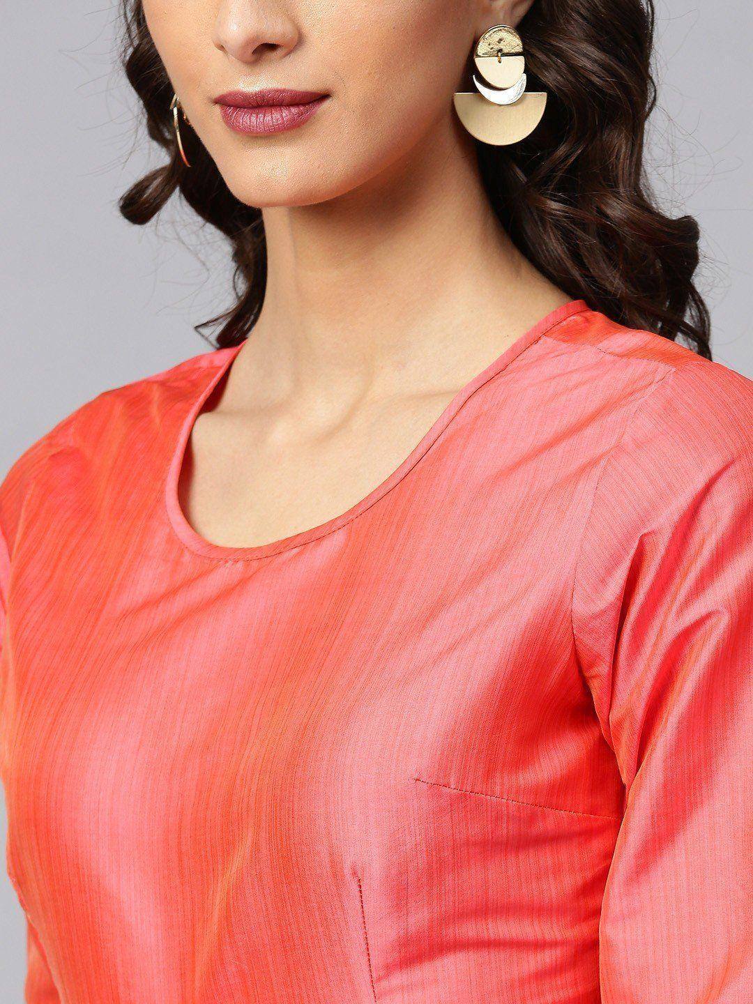 Coral ethnic kurti with round neckline and stylish gold earrings