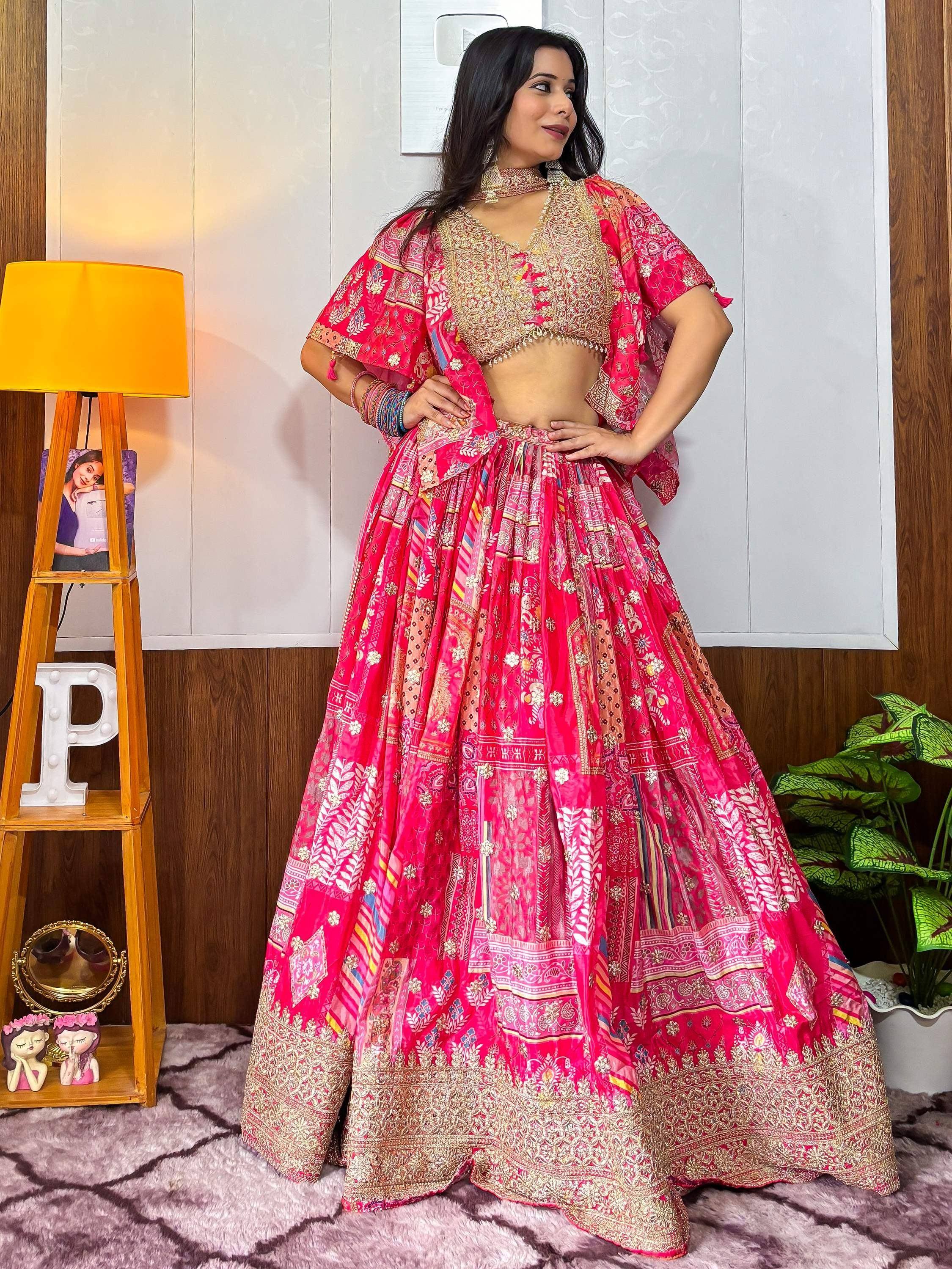 Vibrant pink printed lehenga choli with gold embroidery, perfect for Indian ethnic occasions