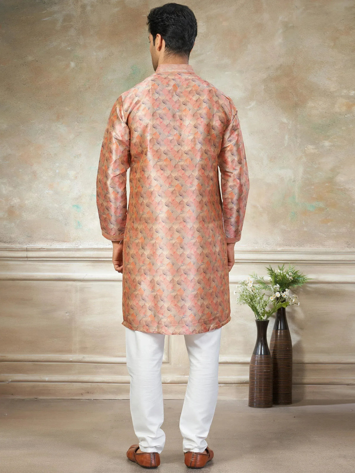 Men's ethnic kurta with peach scale print, paired with white churidar, ideal for festive occasions
