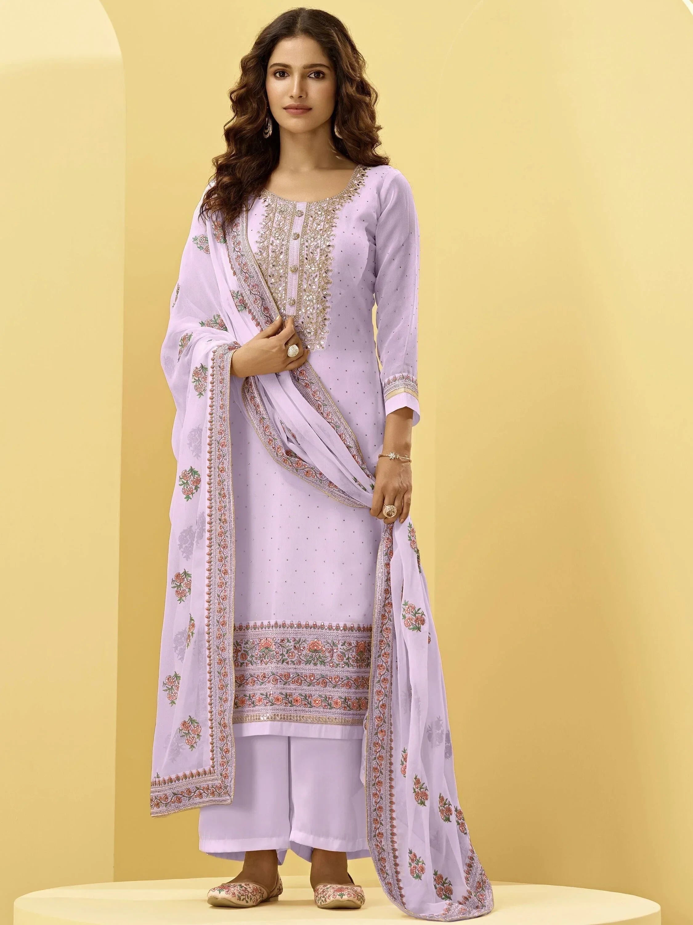 Woman wearing light lavender embroidered salwar kameez with matching dupatta