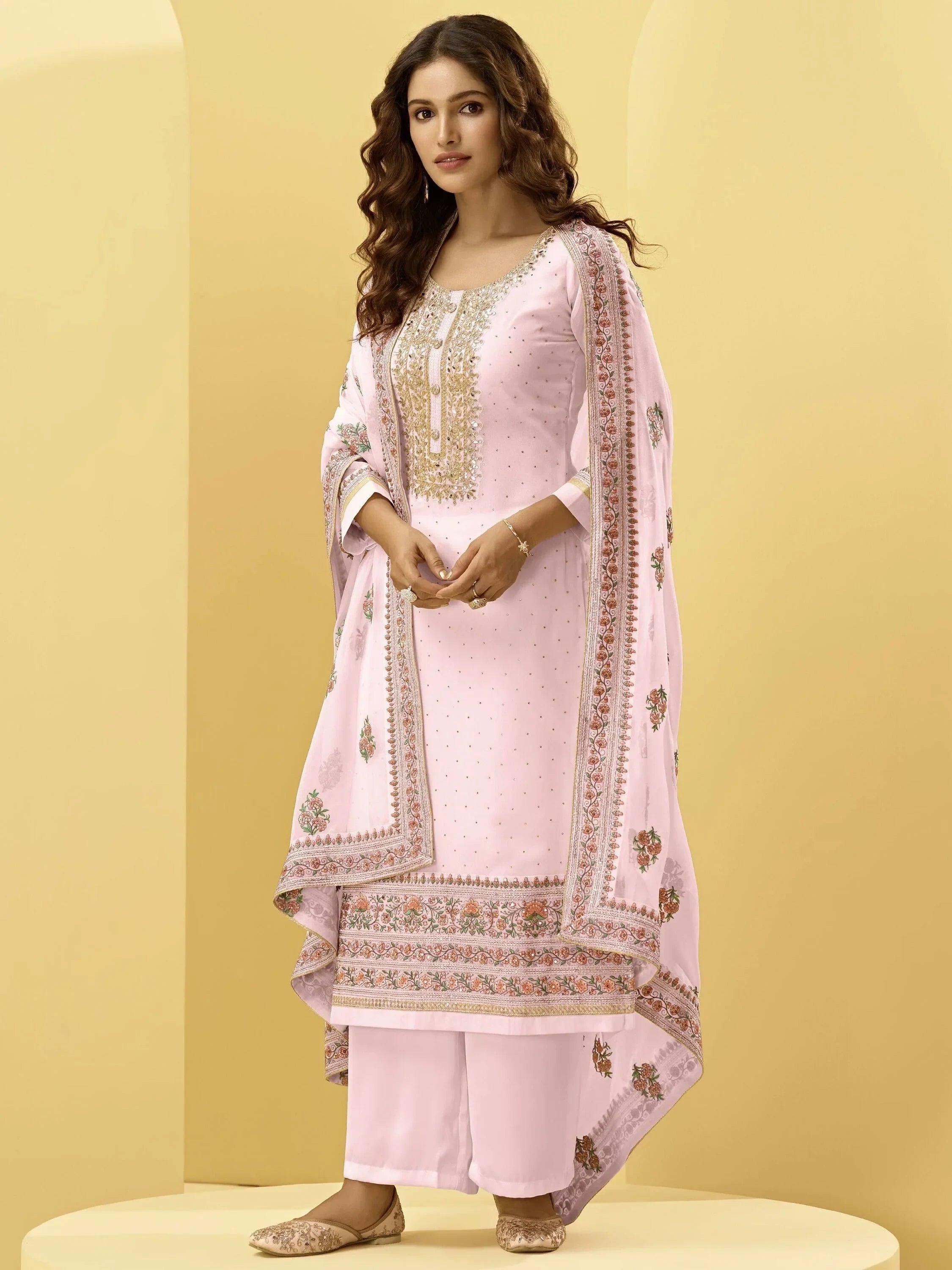 Woman wearing light pink embroidered salwar kameez with dupatta and flats, ethnic wear