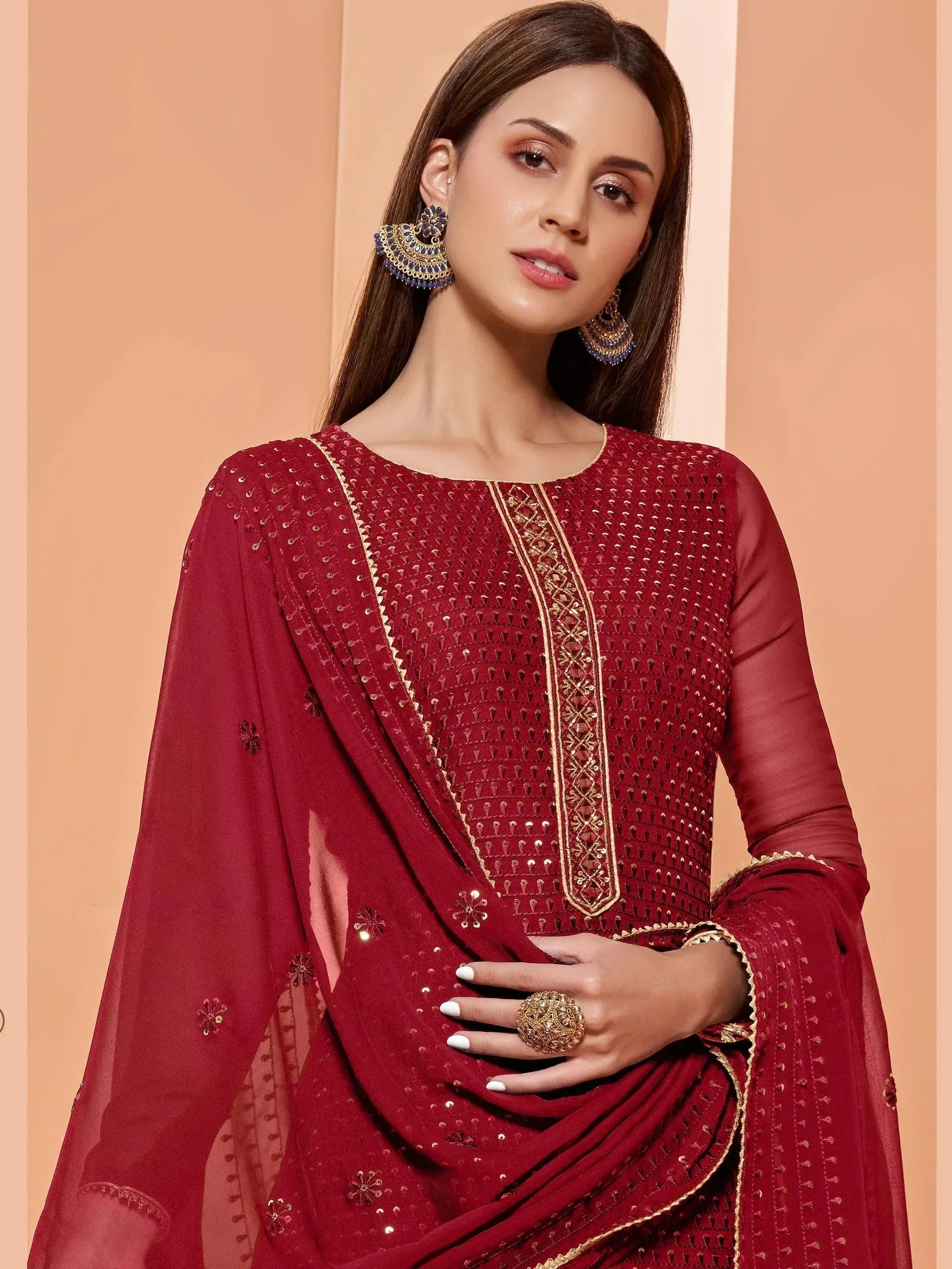 Elegant maroon ethnic salwar kameez with gold embroidery and sequins, perfect for festive occasions.
