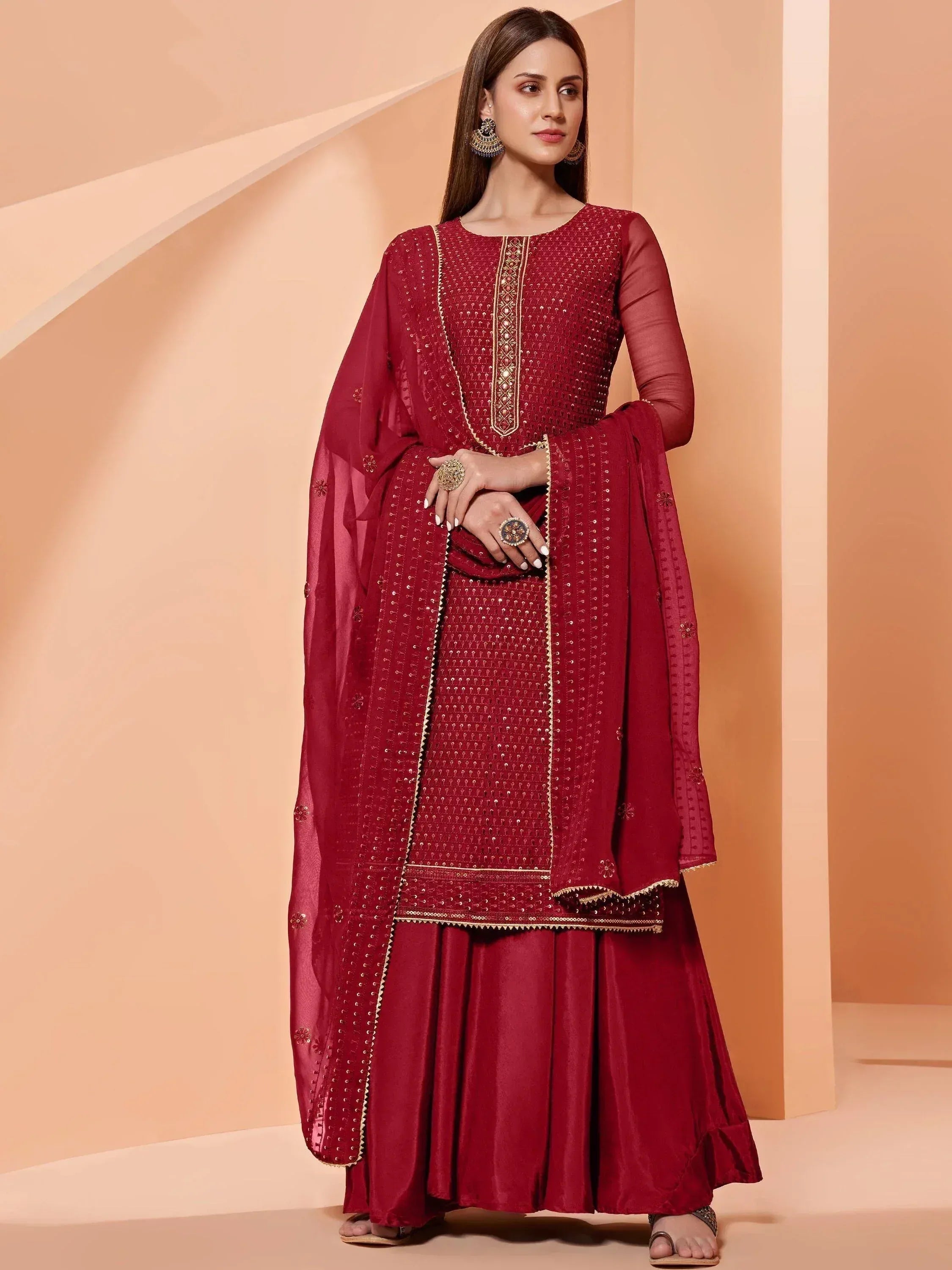 Maroon ethnic salwar kameez with gold embroidery and sheer dupatta for festive occasions