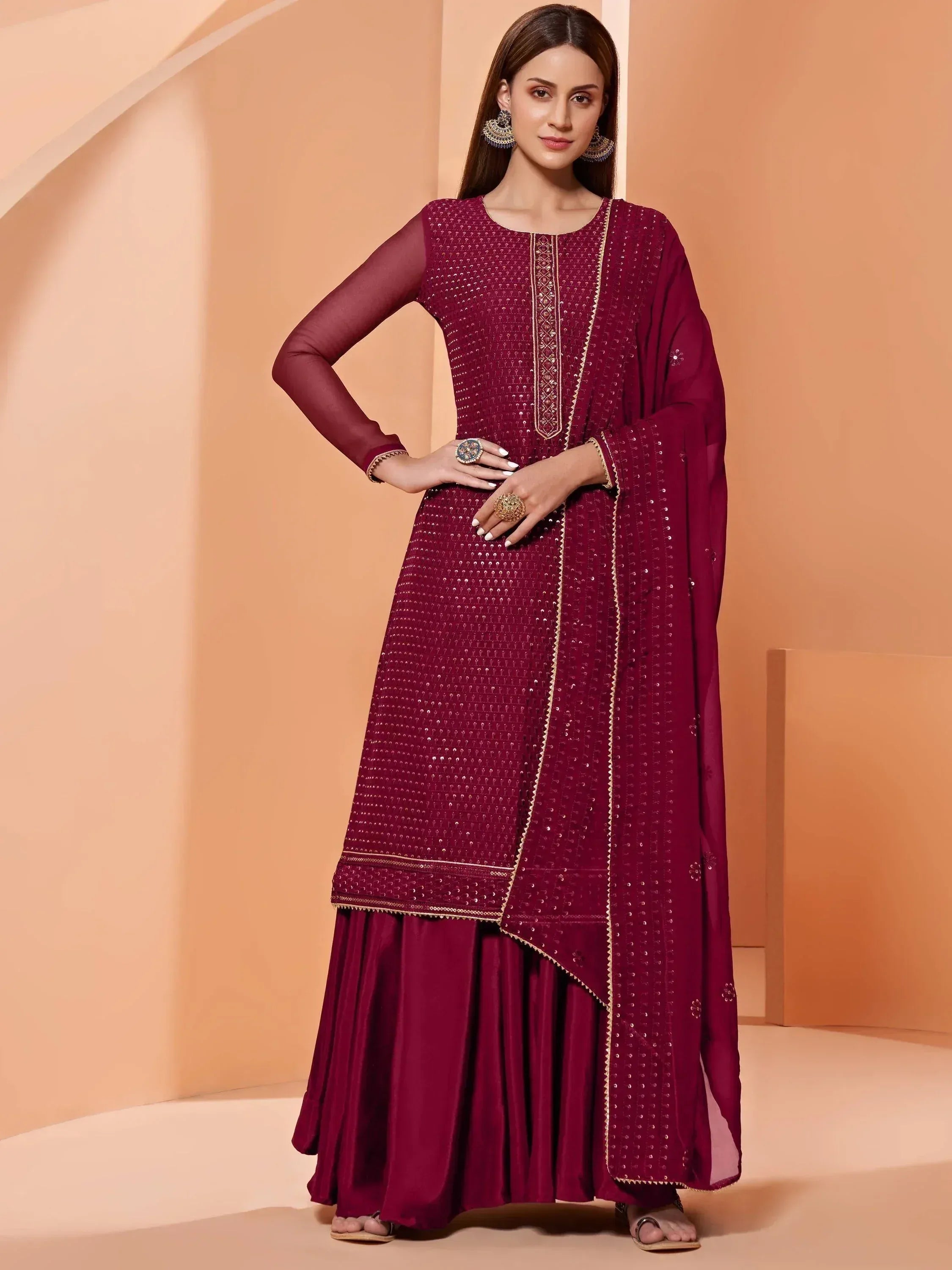 Maroon ethnic anarkali suit with gold embroidery and sequins, perfect for Indian weddings or festive occasions.