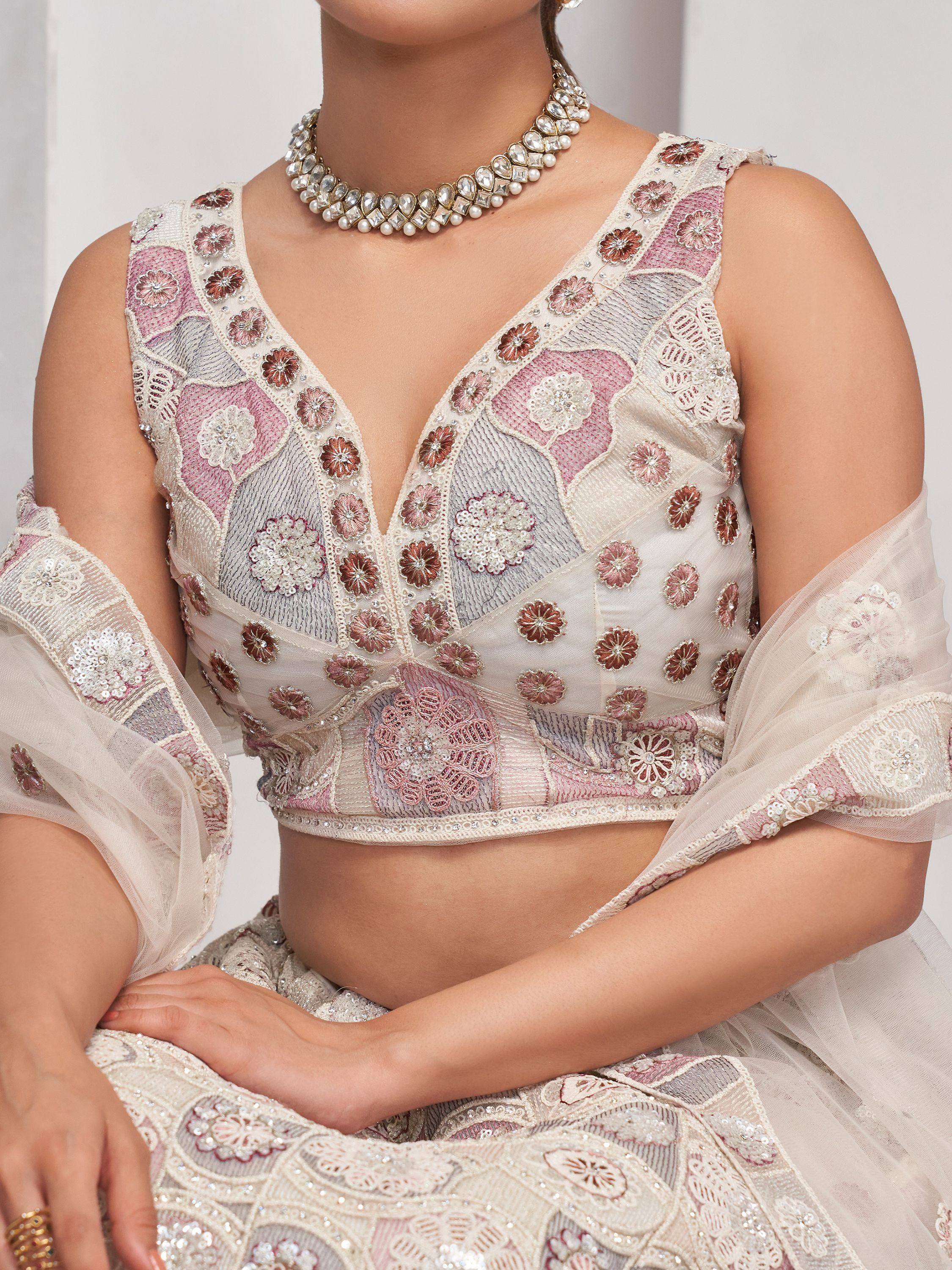 Elegant floral embroidered lehenga choli with sheer sleeves and pearl necklace