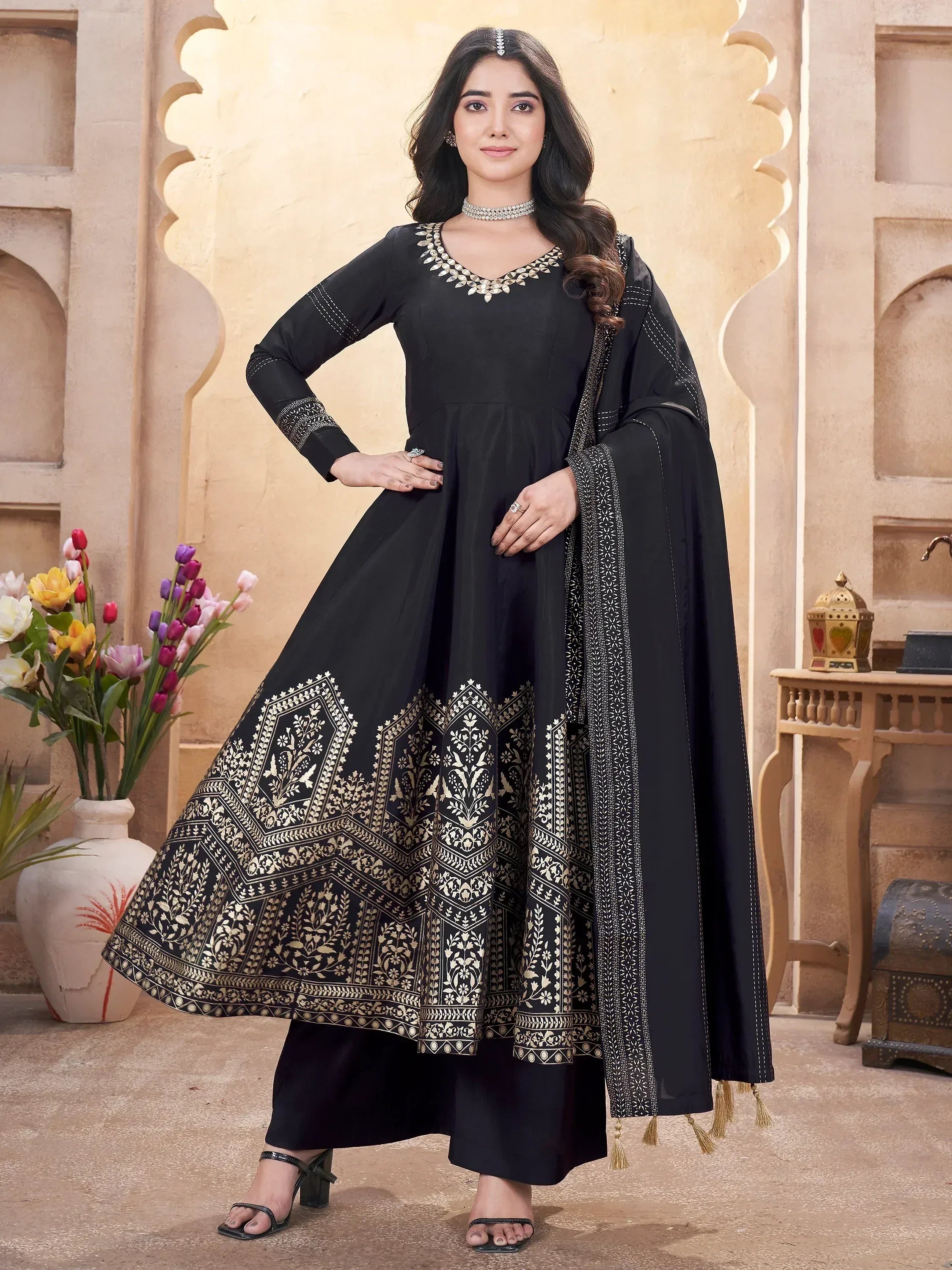 Black ethnic anarkali suit with gold floral print, paired with matching dupatta and palazzo pants