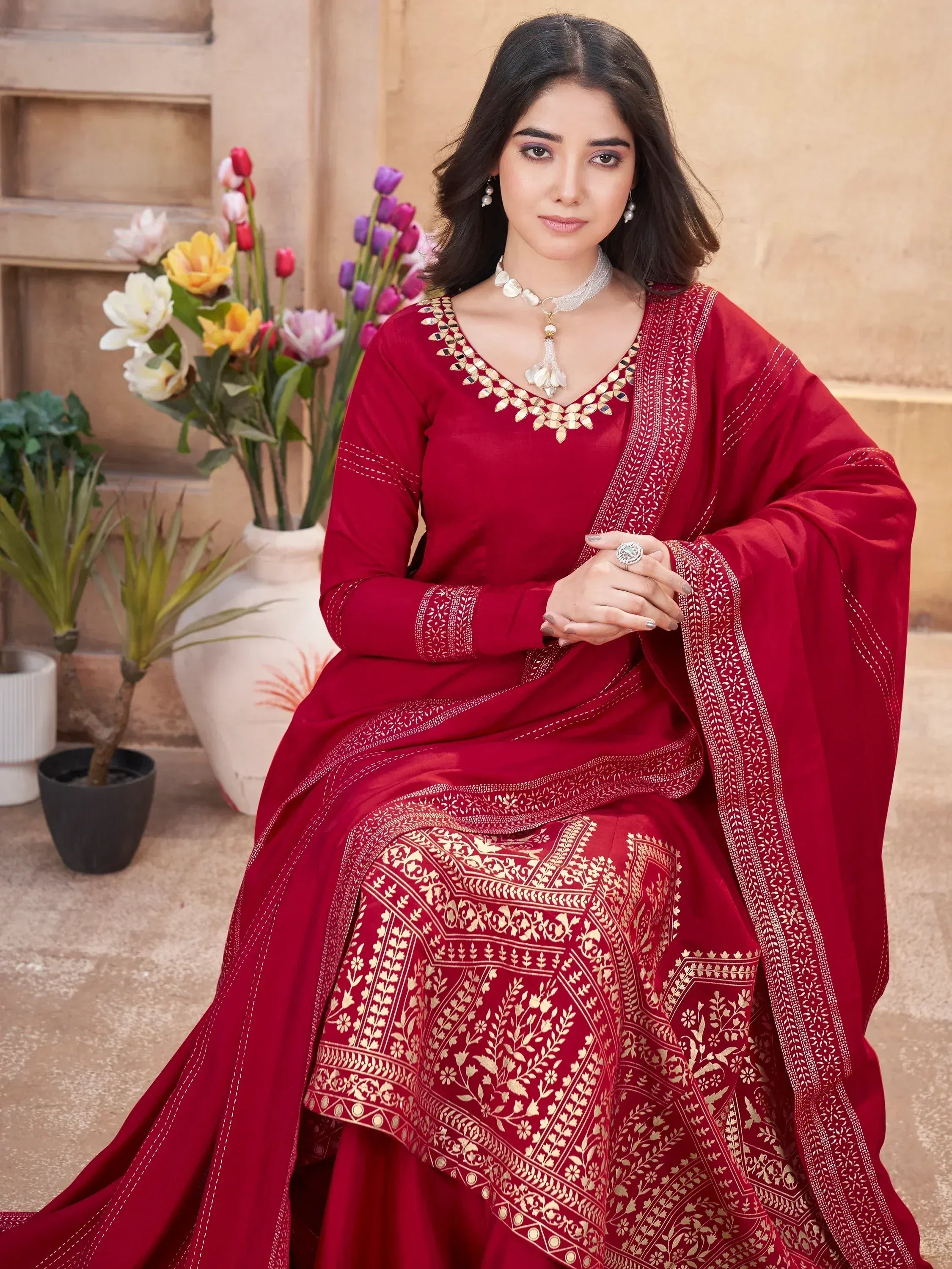 Red ethnic salwar kameez with gold embroidery, perfect for Indian weddings and festive occasions