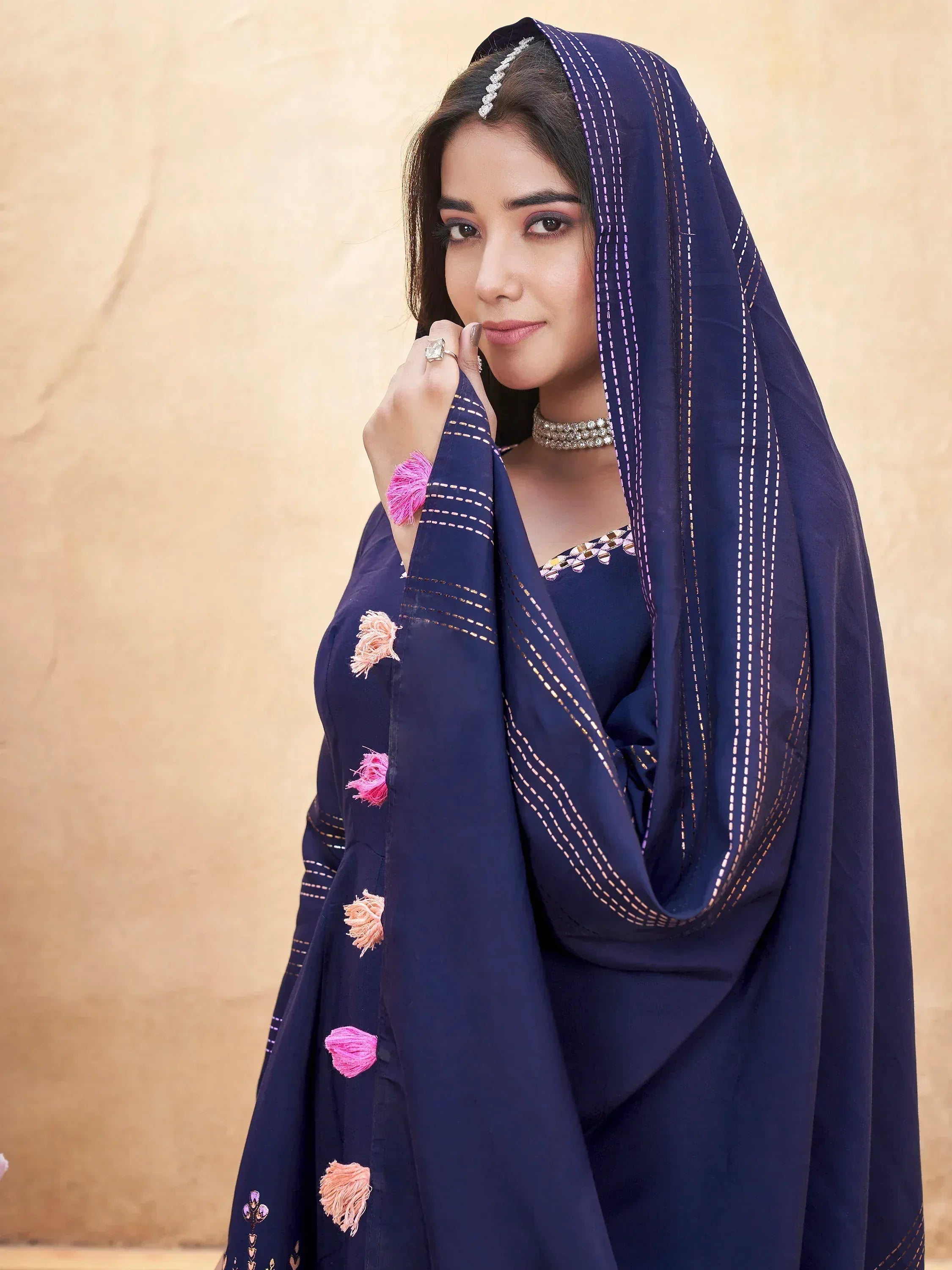 Navy blue ethnic salwar kameez with pink tassels and threadwork dupatta, perfect for Indian festive wear.