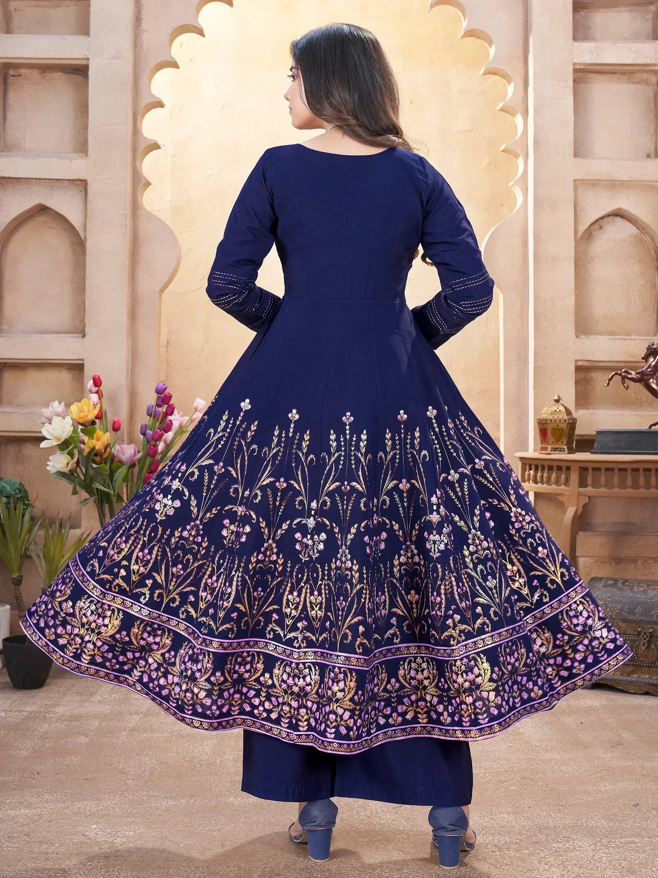 Navy blue ethnic anarkali gown with gold and purple floral embroidery, perfect for Indian occasions.