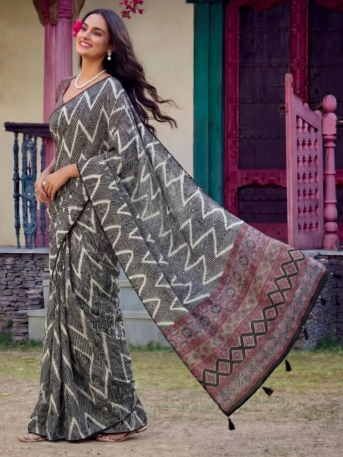 Woman in black and white geometric print saree with colorful border, styled for Indian ethnic wear
