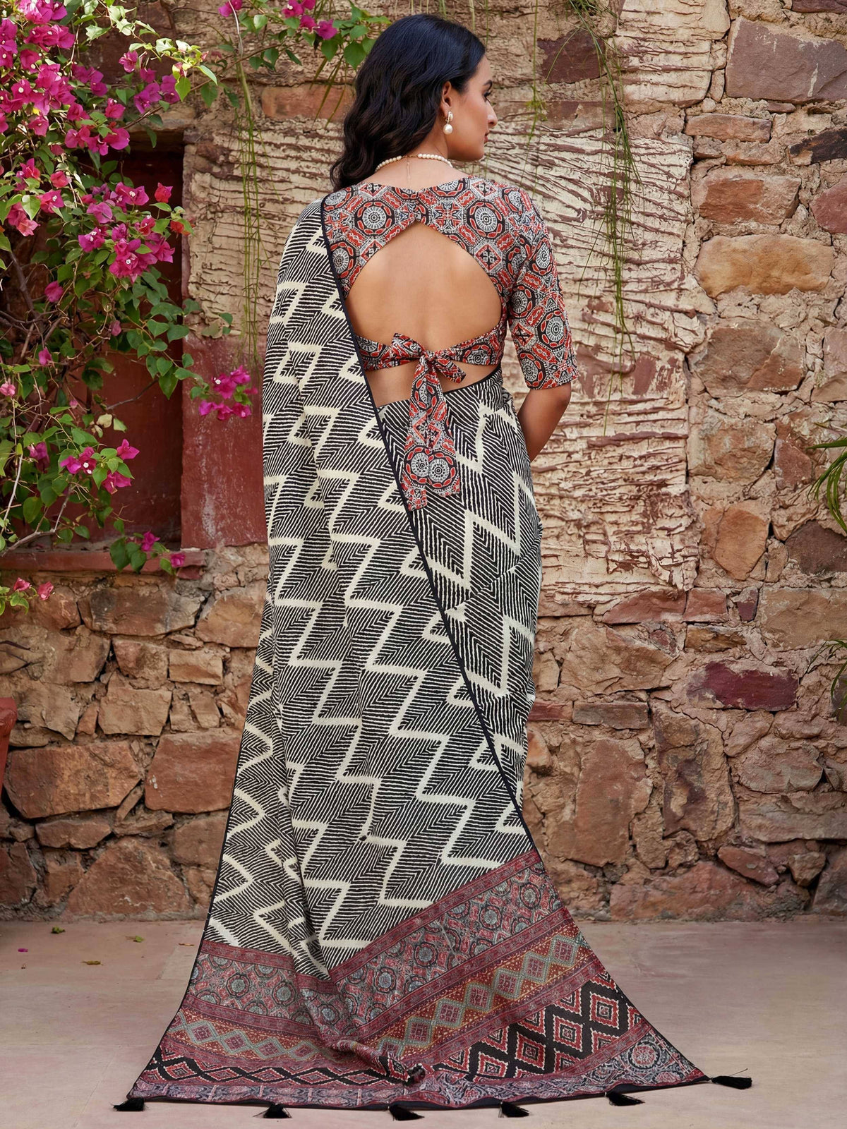 Woman in printed saree with backless blouse, ethnic wear for festive occasions