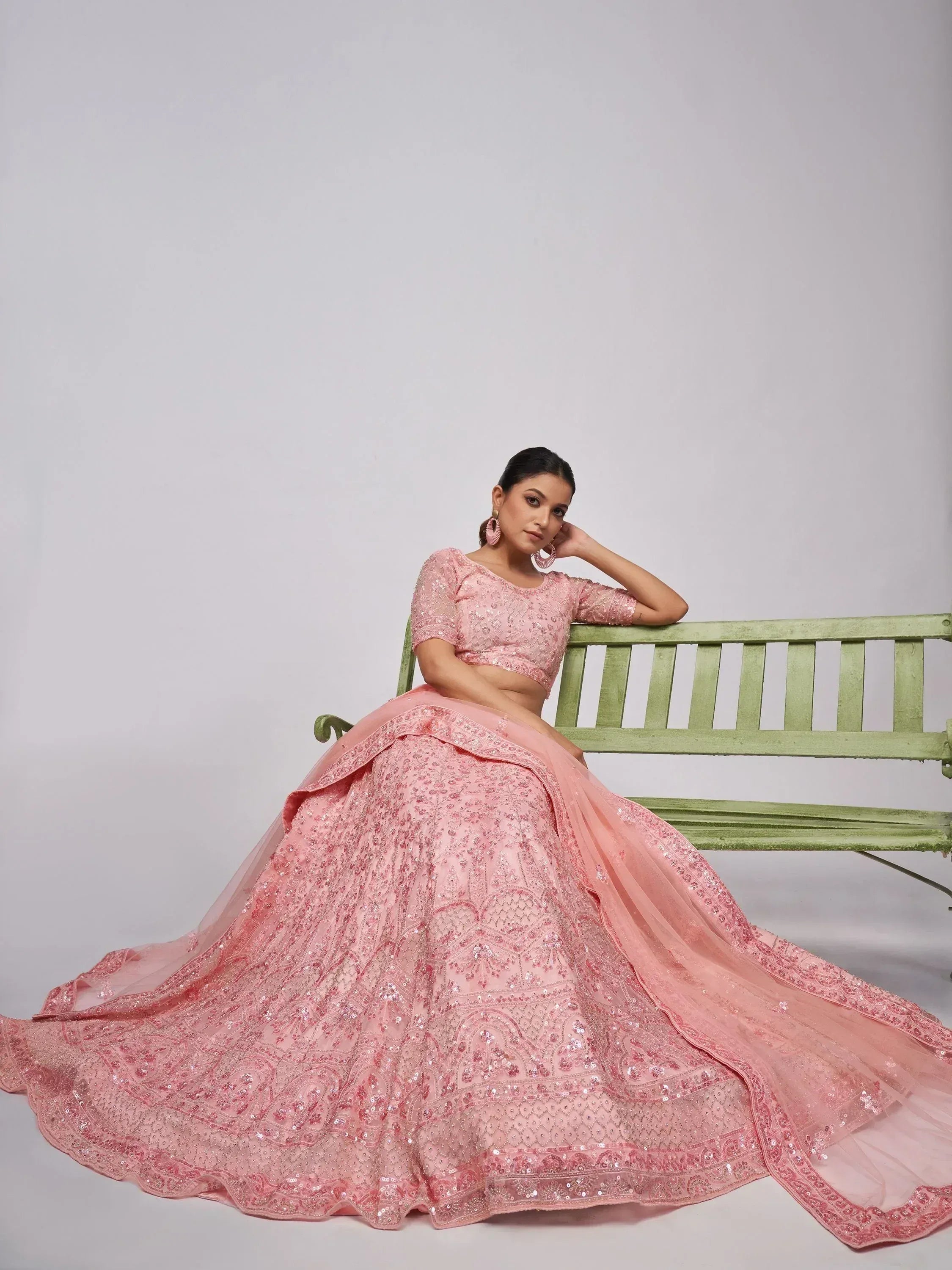 Elegant pink embroidered lehenga choli with sequins, styled for Indian ethnic wear