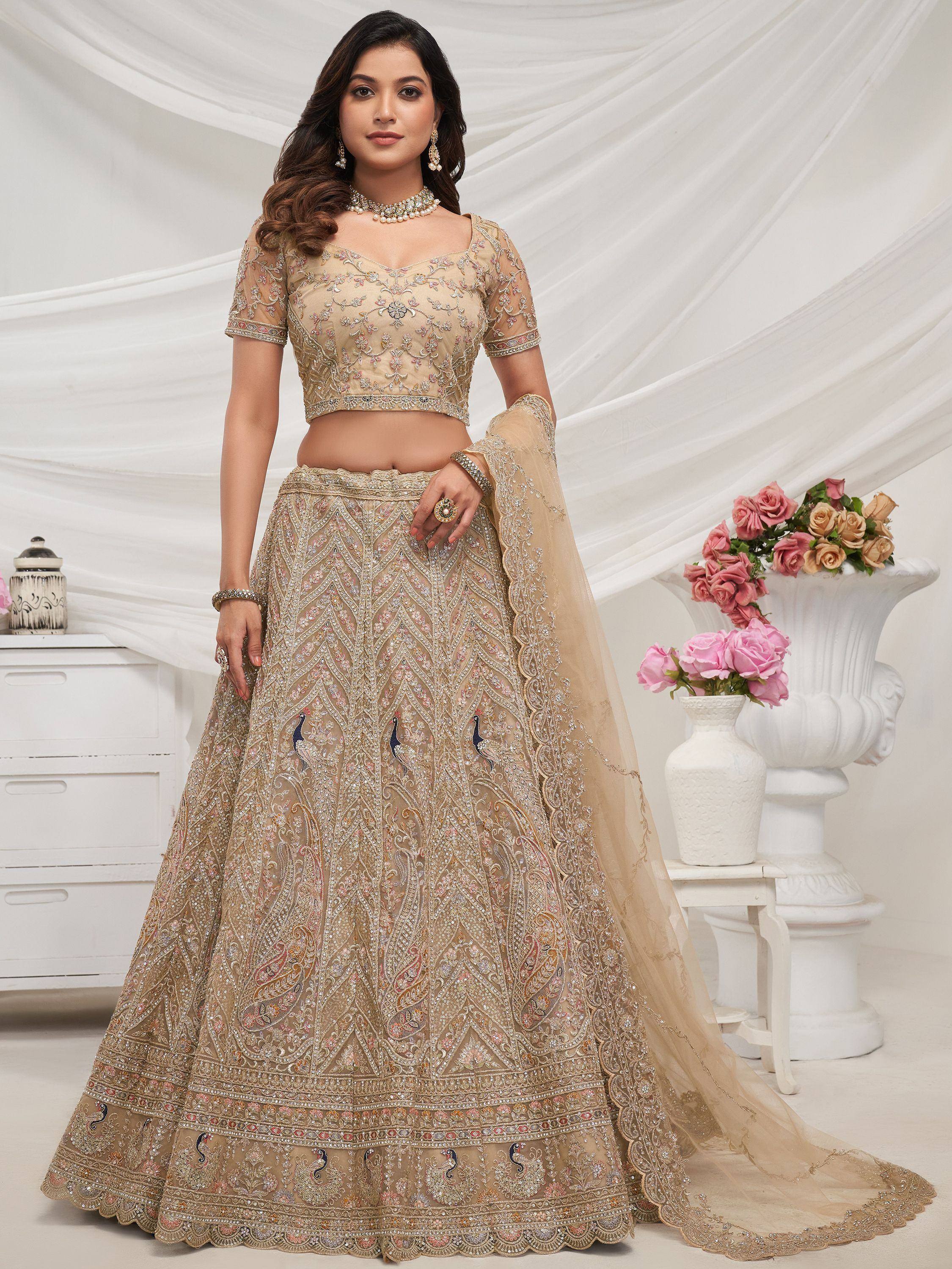 Beige embroidered lehenga choli with peacock motifs, perfect for Indian weddings and festive occasions.