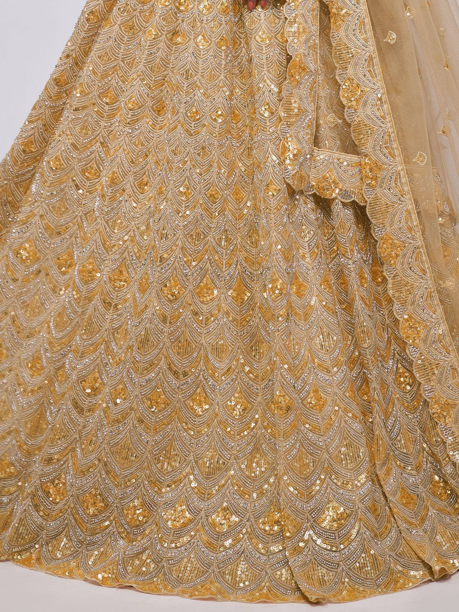 Golden sequin lehenga with intricate feather pattern, perfect for Indian ethnic wear events