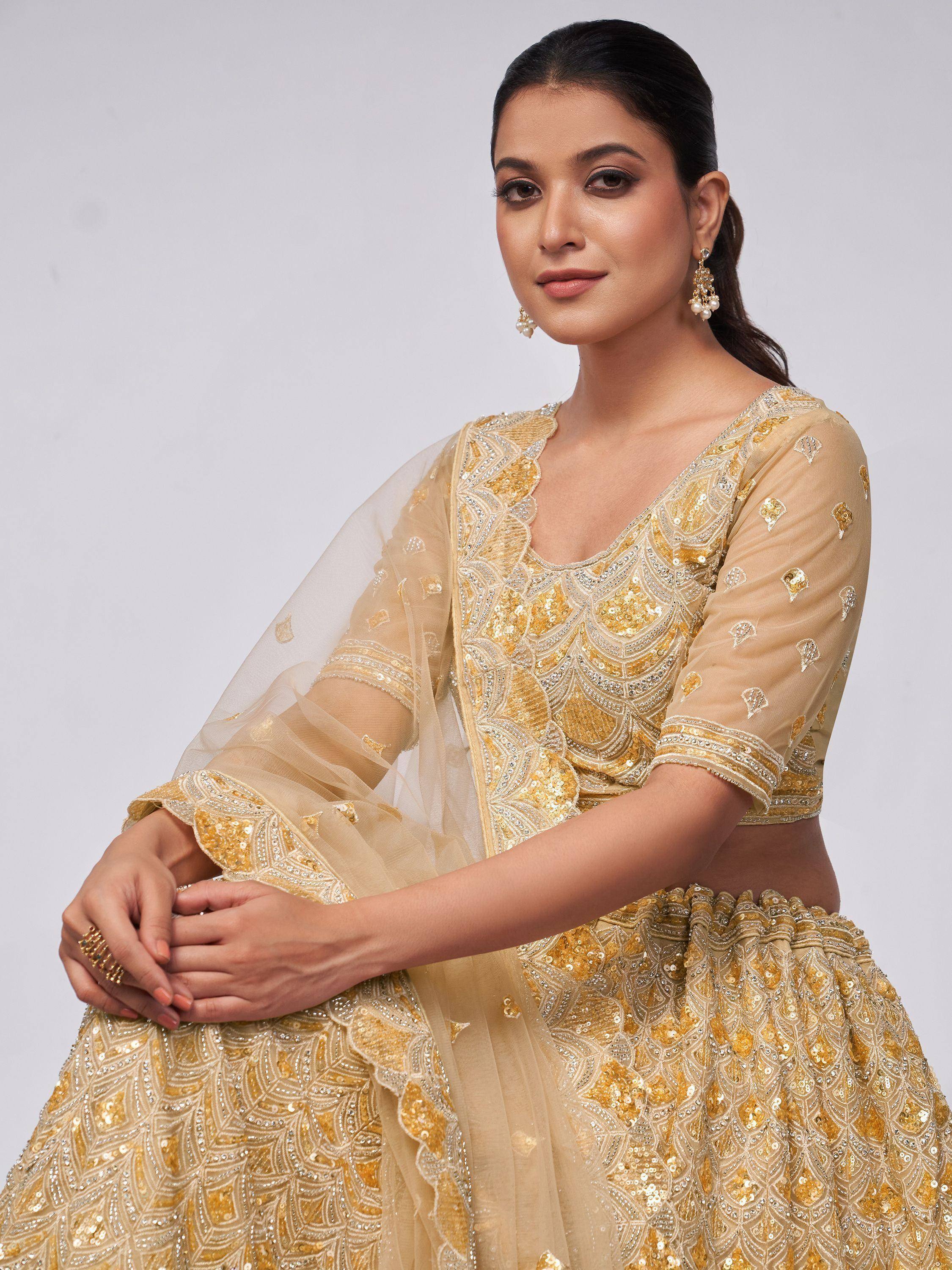 Elegant gold sequin lehenga choli with sheer dupatta, perfect for Indian ethnic wear occasions