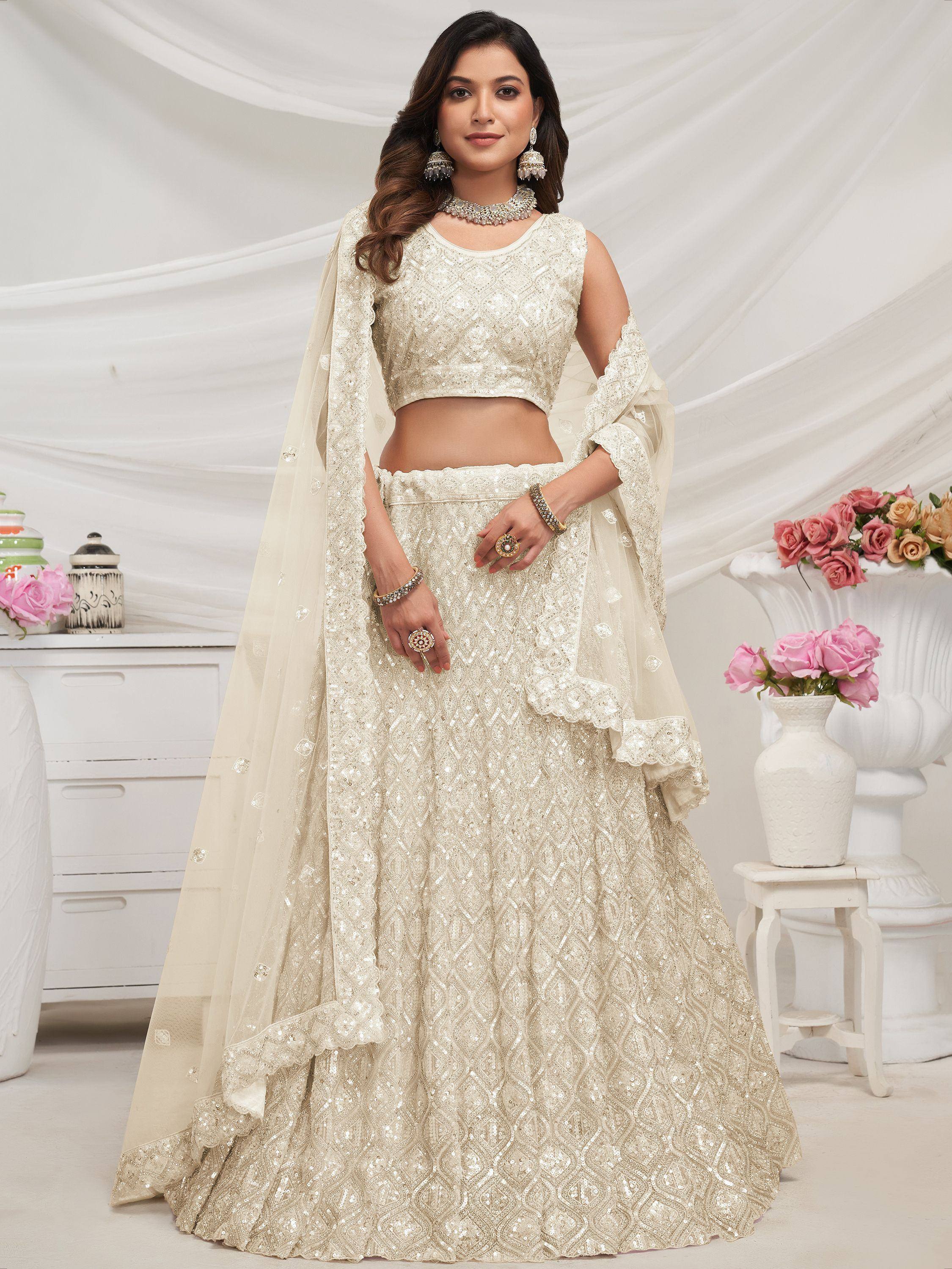 Ivory designer lehenga choli with intricate embroidery and sequin work, perfect for weddings and festive occasions.