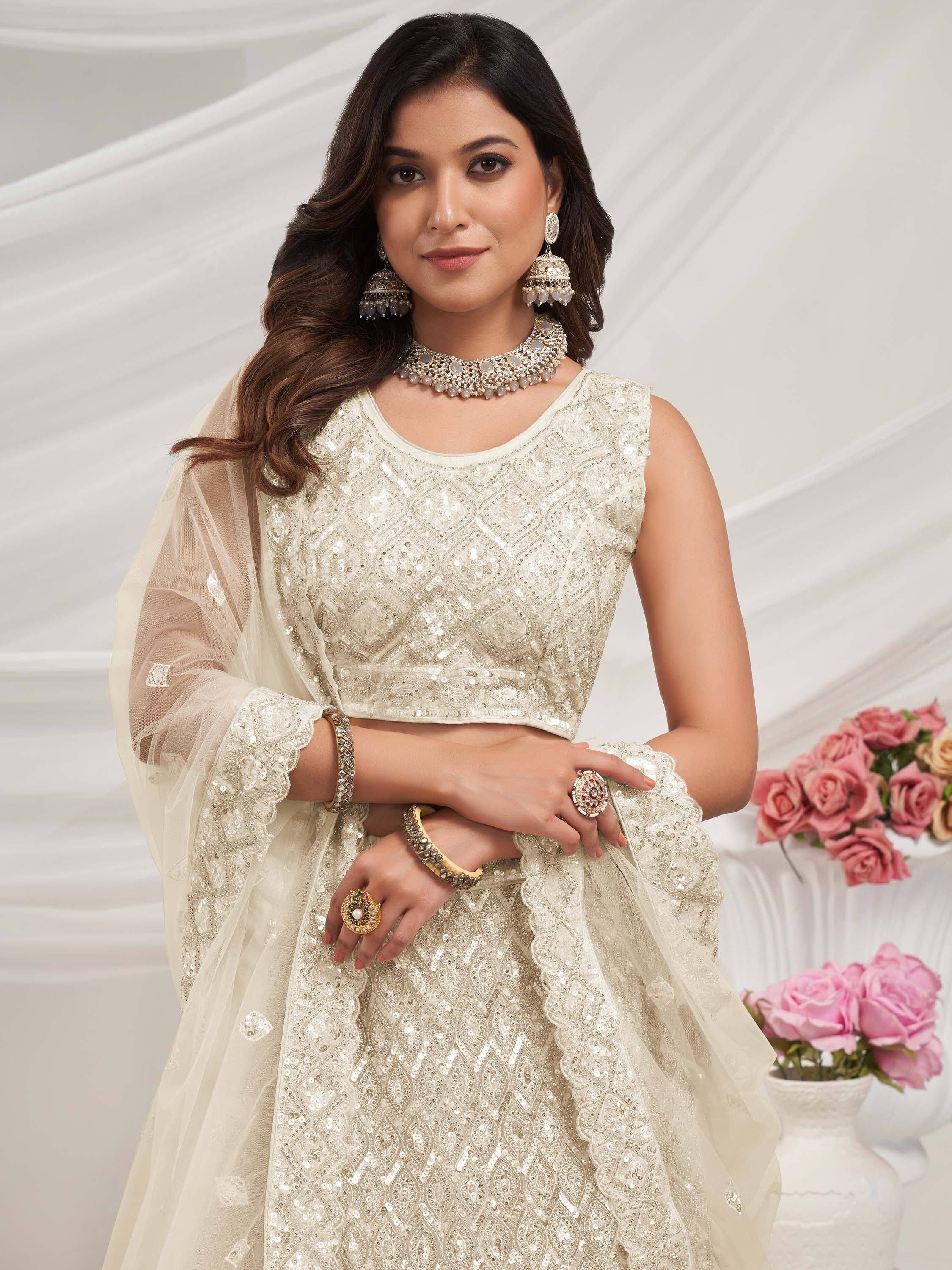 Elegant ivory sequin lehenga choli with sheer dupatta, perfect for Indian weddings and festive occasions.